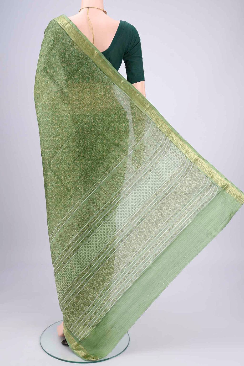 Flat view of Light Green Printed Silk Saree with Printed design on the body and Zari Border. 