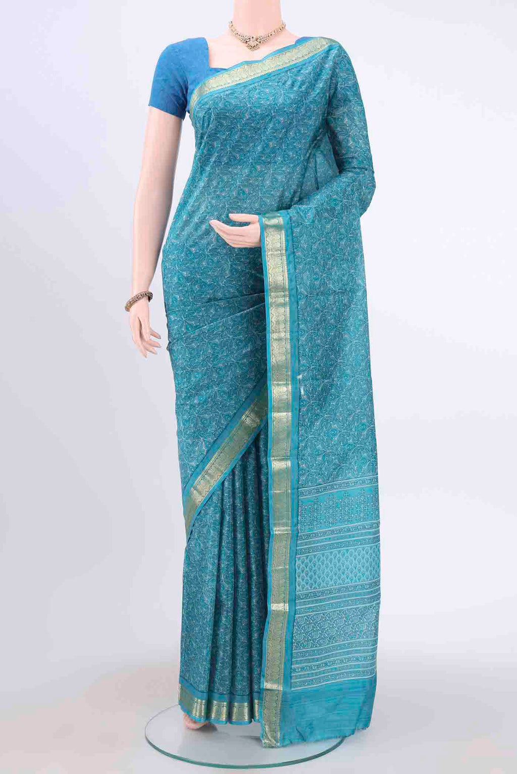 Blue Printed Silk Saree with Floral Print on the body and Zari Border displayed on a mannequin