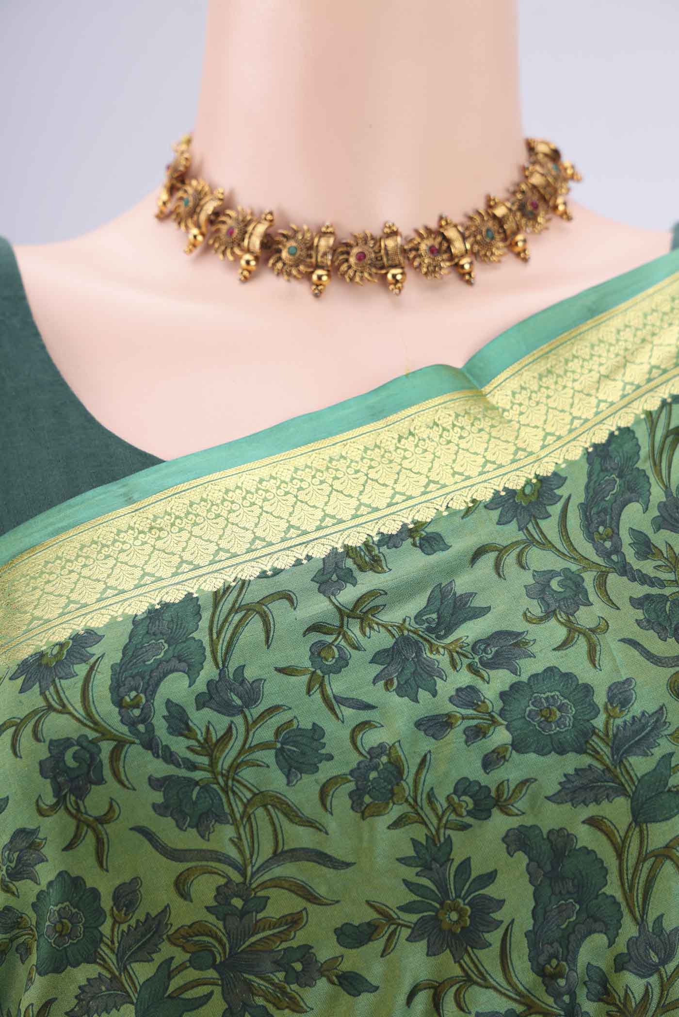 Border image of Green Printed Silk Saree with Printed design on the body and Zari Border. 