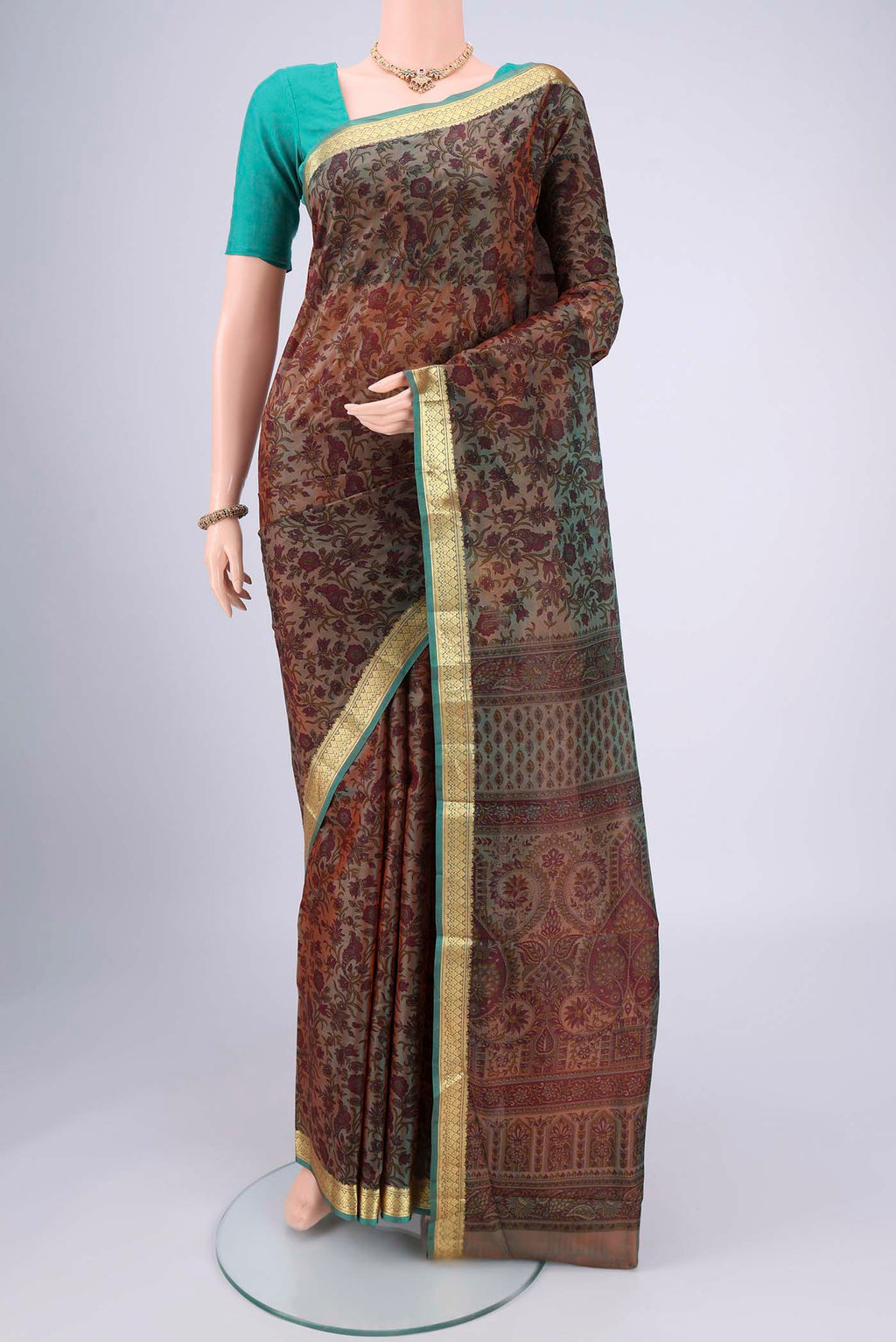 Pickle Green Dual Tone Printed Silk Saree with Printed design on the body and Zari Border.  displayed on a mannequin
