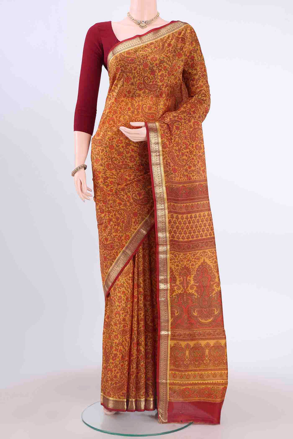 Yellow Printed Silk Saree with Floral Print on the body and Zari Border displayed on a mannequin