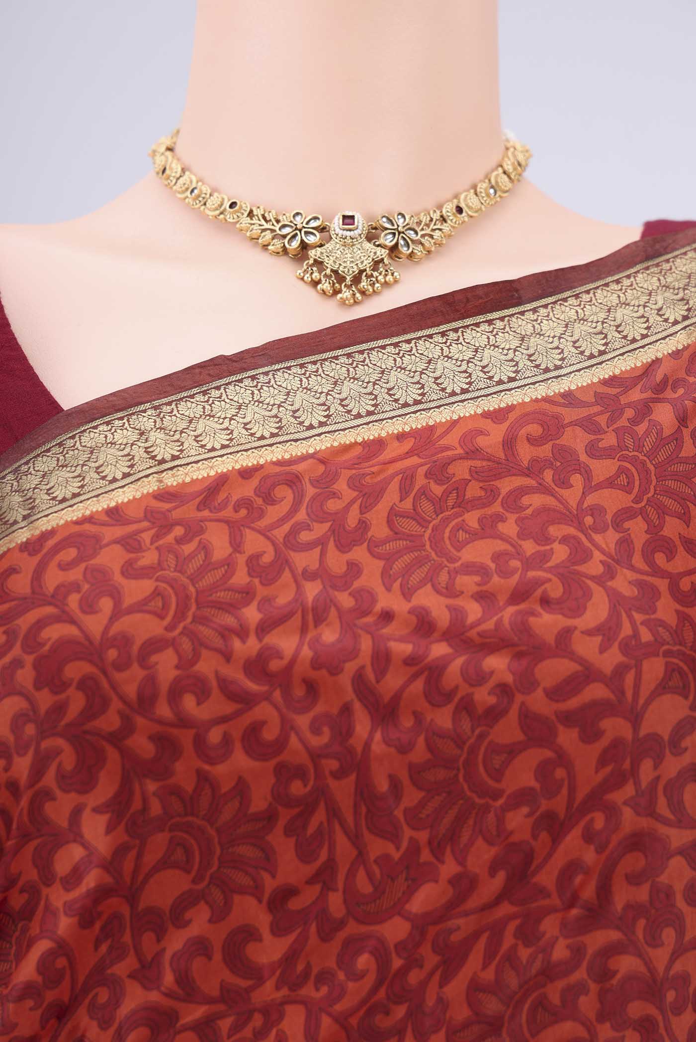 Border image of Rust Printed Silk Saree with Printed design on the body and Zari Border. 