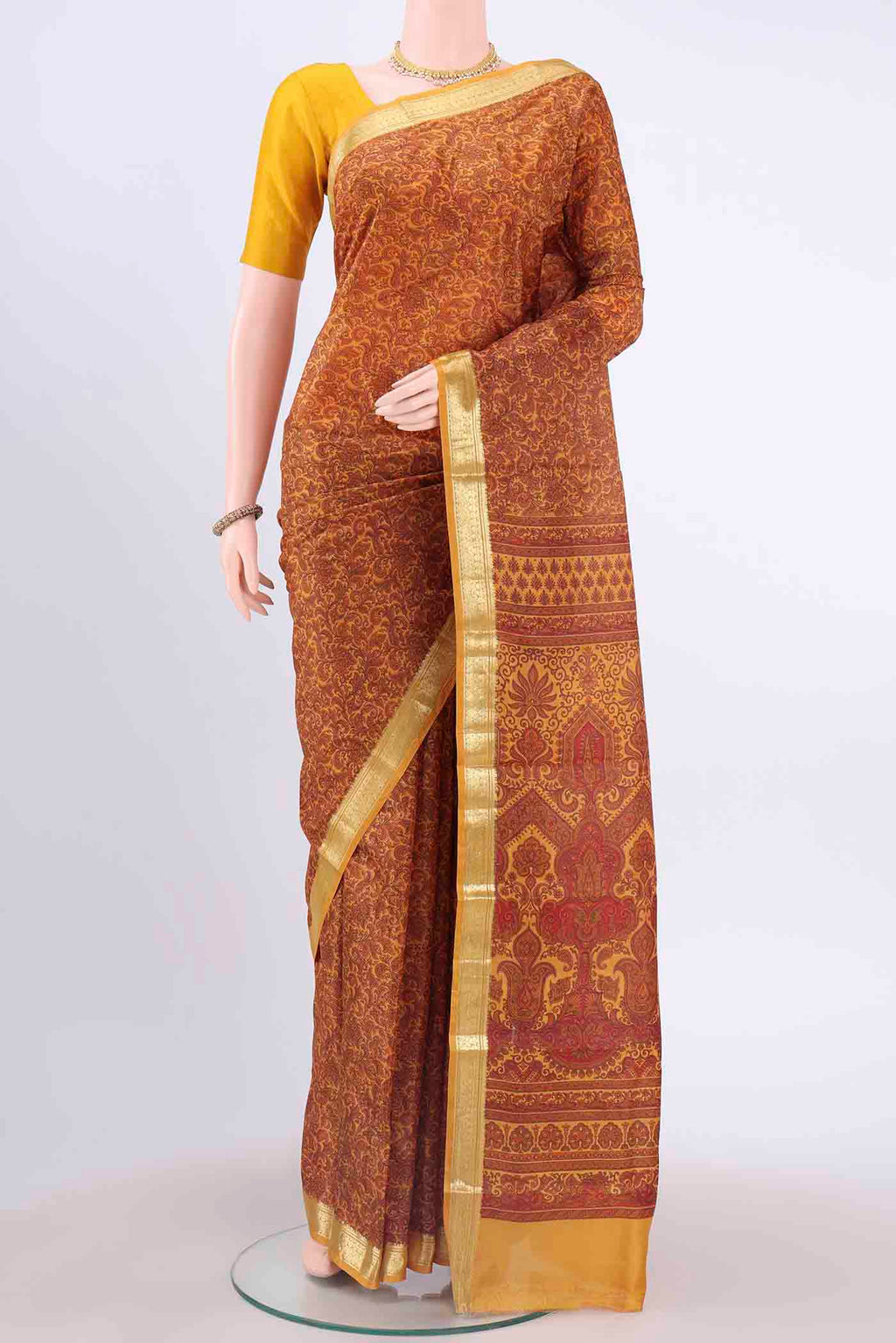 Mustard Printed Silk Saree with Floral Print on the body and Zari Border displayed on a mannequin