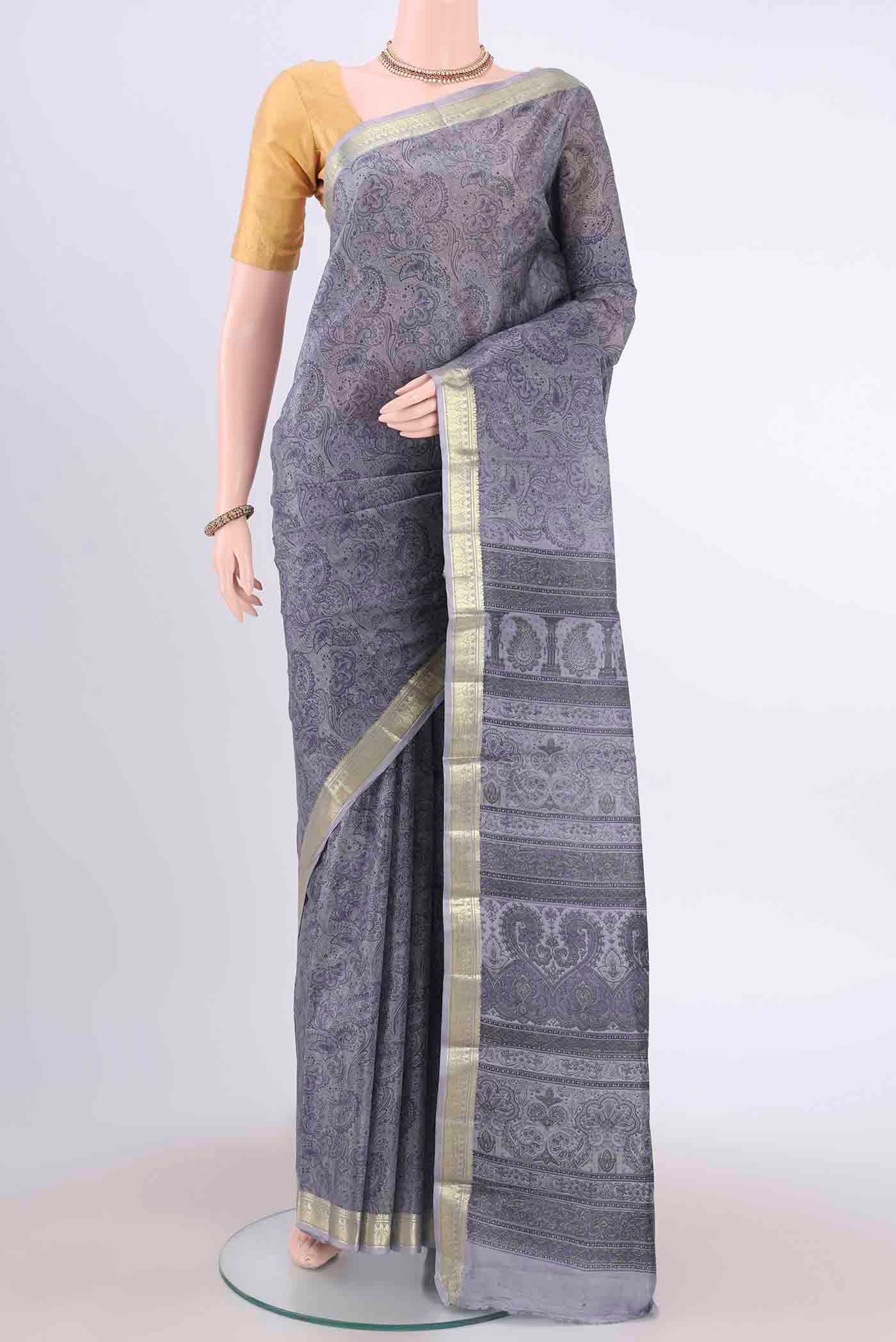 Blue Grey Printed Silk Saree with Floral Print on the body and Zari Border displayed on a mannequin