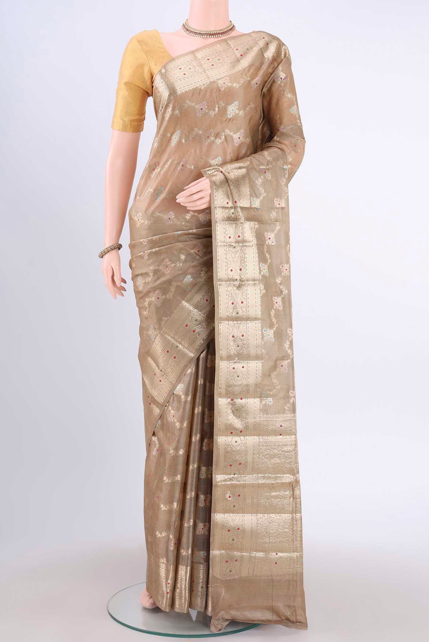 Beige Banarasi Tussar Silk Saree with Zari And Thread Butta on the body and Zari Border displayed on a mannequin