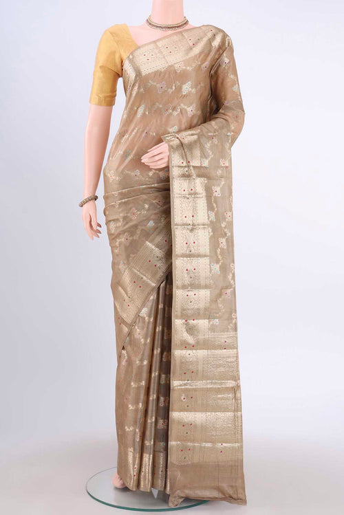 Beige Banarasi Tussar Silk Saree with Zari And Thread Butta on the body and Zari Border displayed on a mannequin