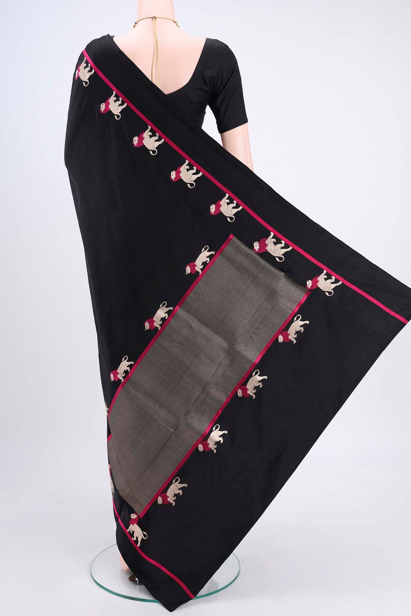 Flat view of Black Banarasi Silk Saree with Plain Body and Zari And Thread Border. 