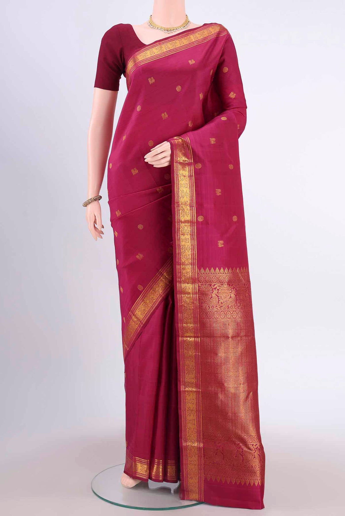 Maroon Kanchipuram Silk Saree with Zari Butta on the body and Zari Border displayed on a mannequin