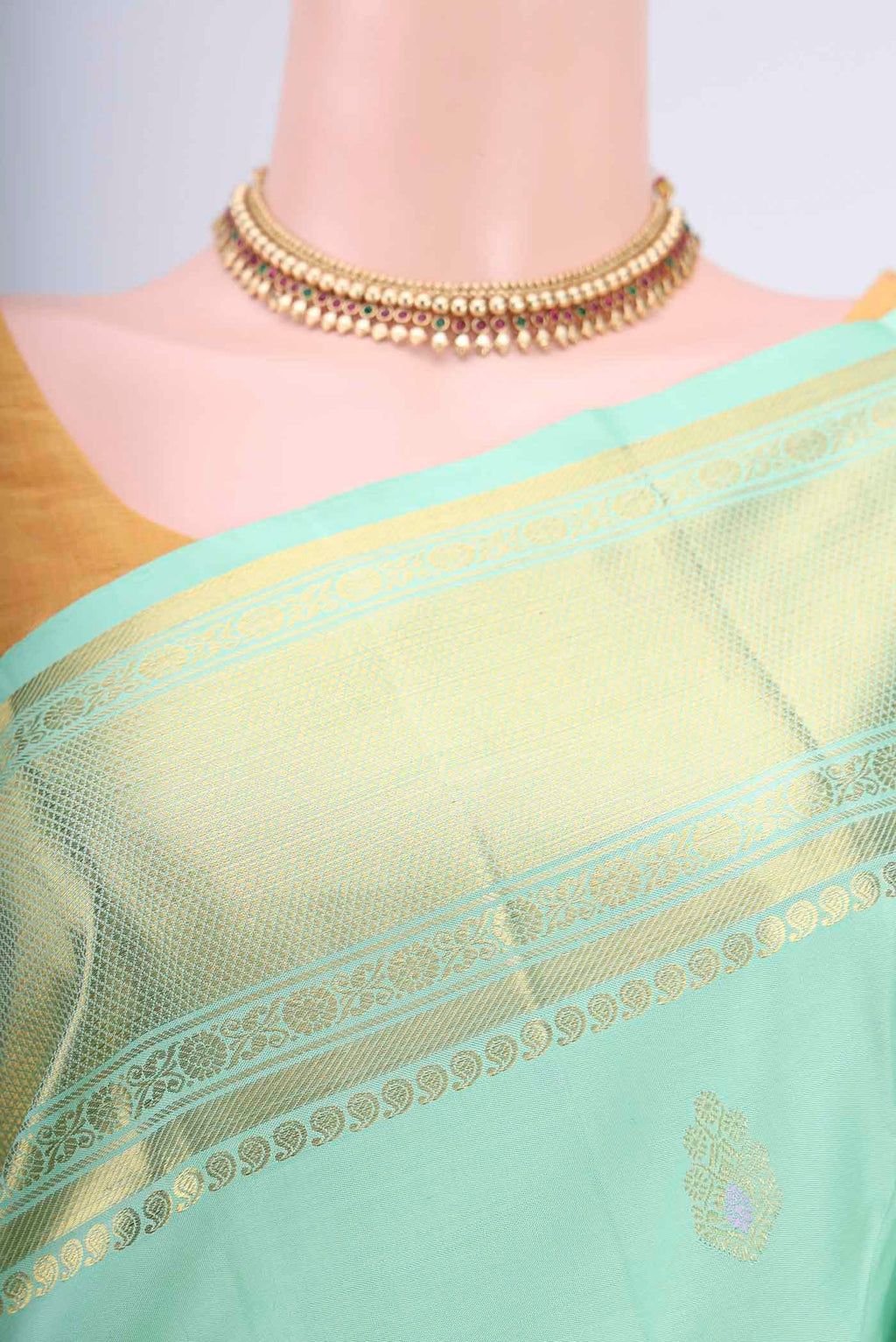 Border image of Mint Green Kanjivaram Saree with Zari And Thread Butta on the body and Zari Border. 