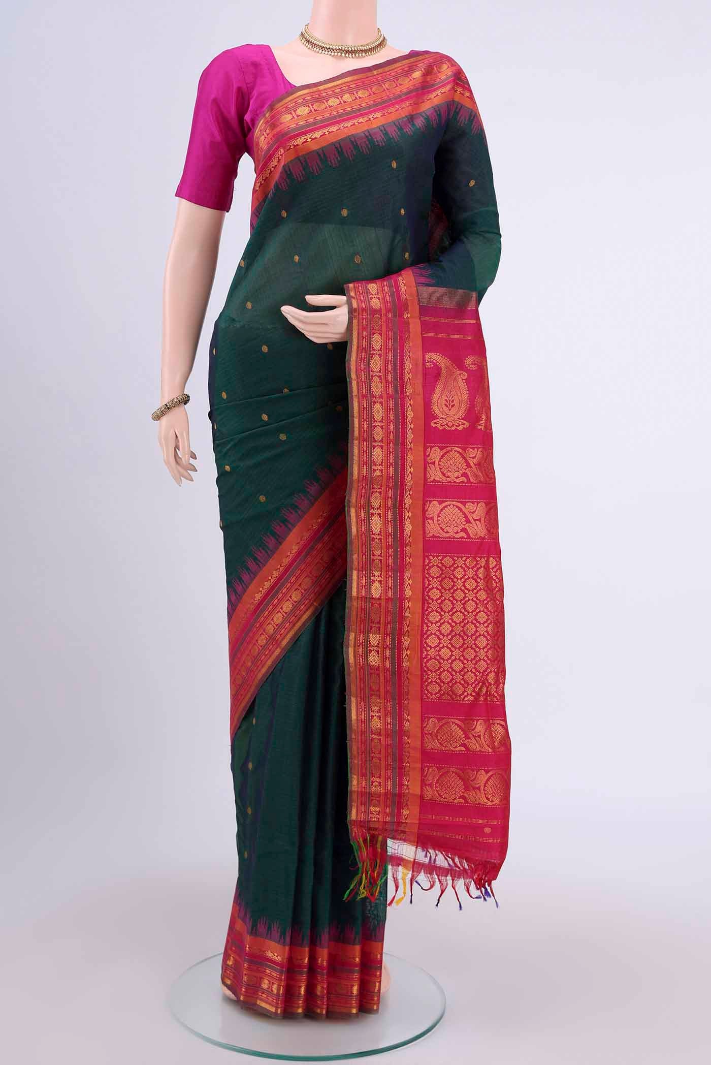 Bottle Green Gadwal Silk Saree with Zari Butta on the body and Zari Border displayed on a mannequin