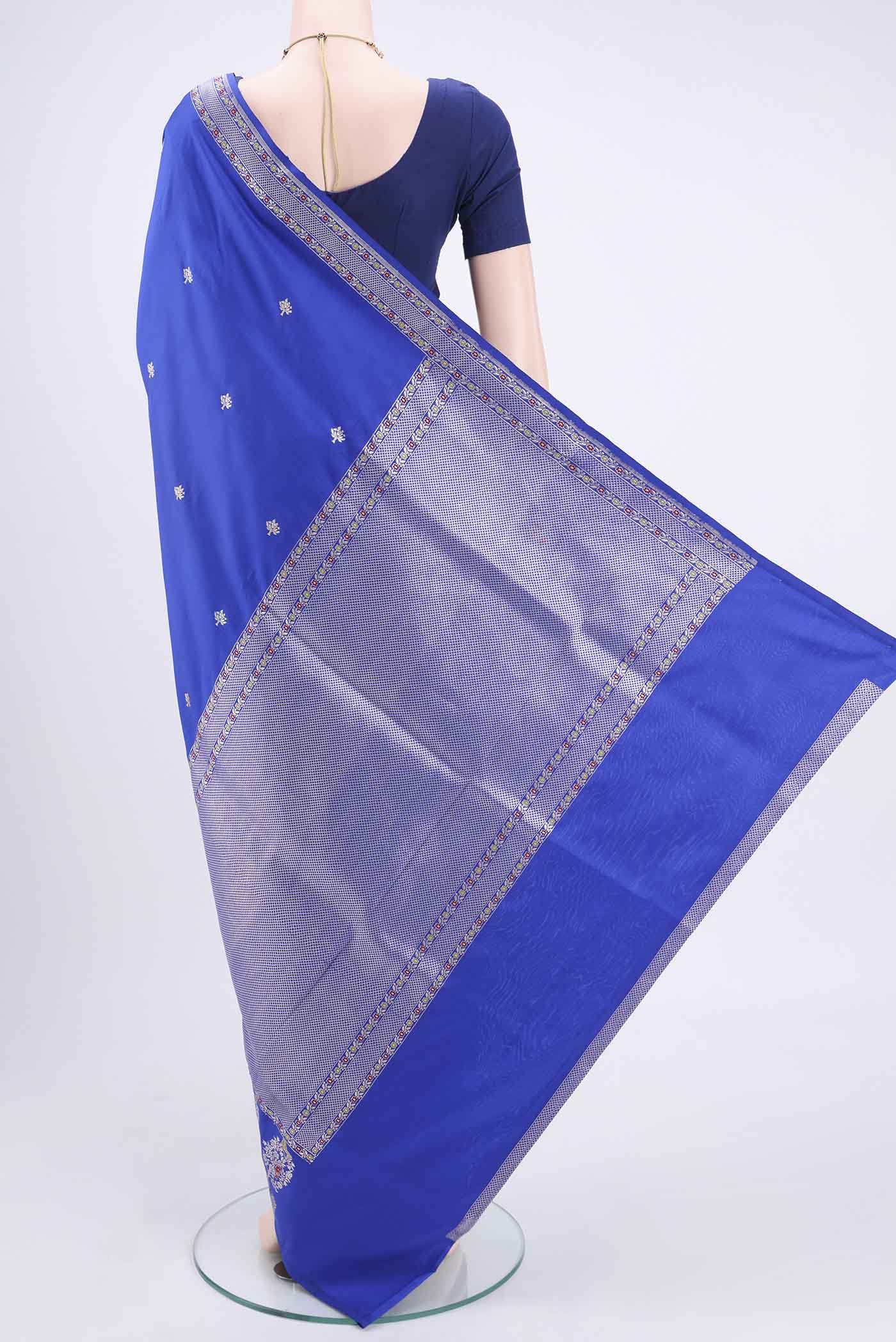 Flat view of Royal Blue Banarasi Silk Saree with Zari Butta on the body and Zari And Thread Border. 