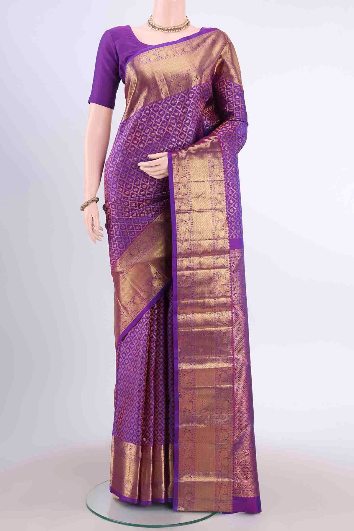 Purple Kanchipuram Silk Saree with Zari Brocade on the body and Zari Border displayed on a mannequin