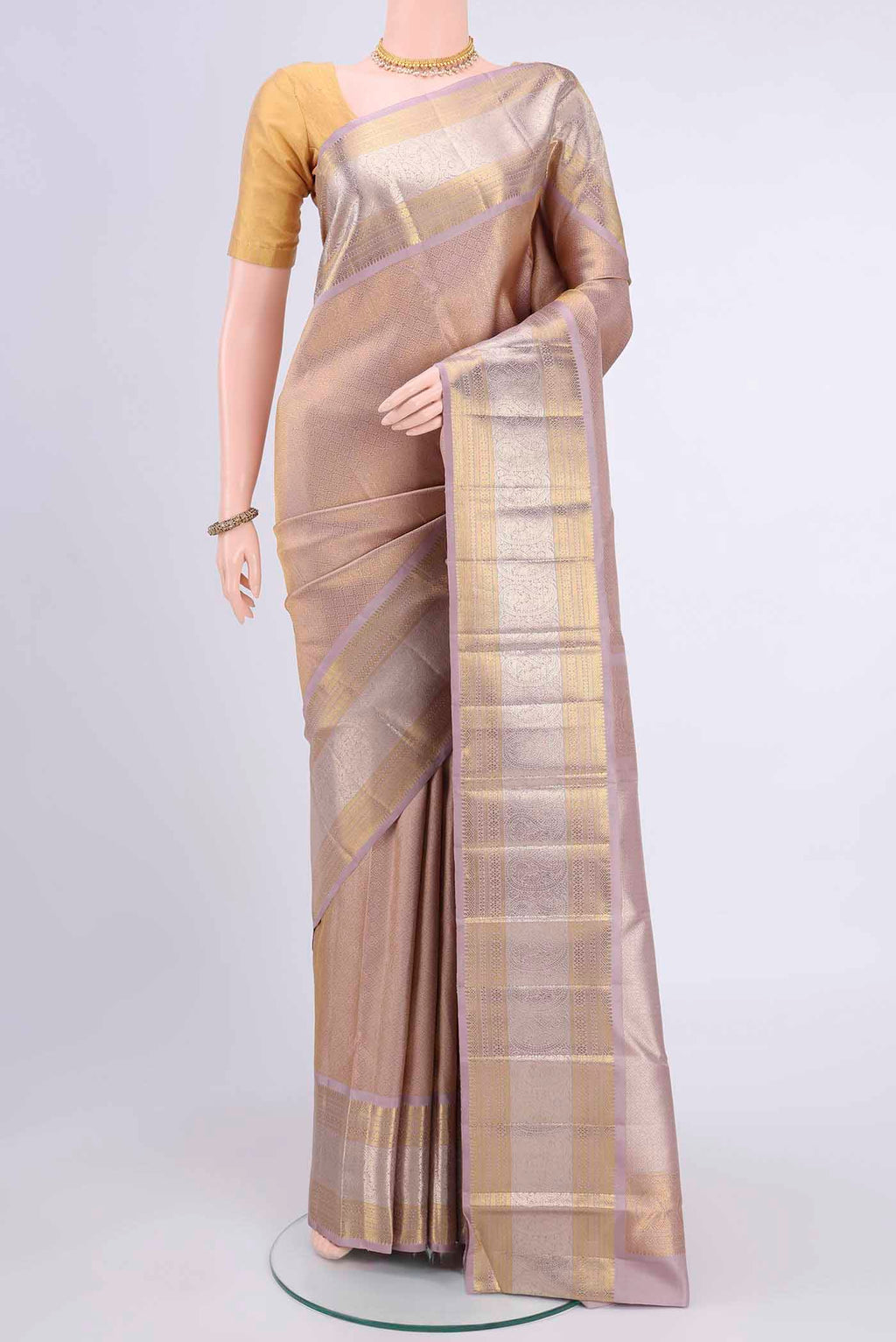 Mauve Kanchipuram Saree with Zari Brocade on the body and Zari Border displayed on a mannequin