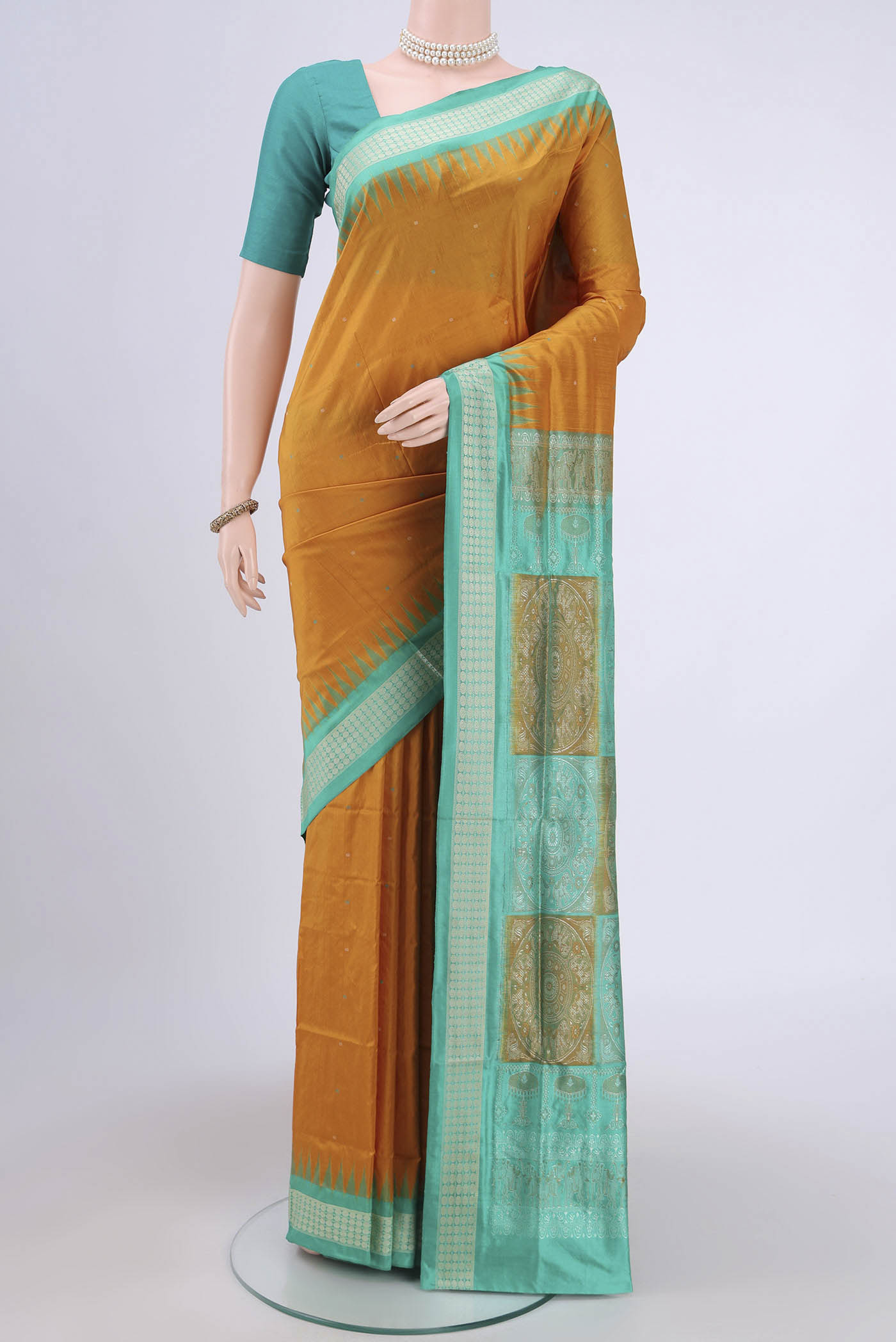 Mustard Orissa Silk Saree with Thread Butta on the body and Thread Border.  displayed on a mannequin