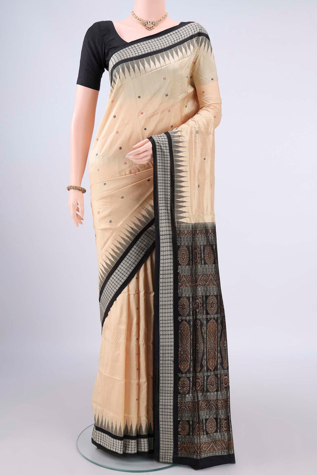Pure Silk Cream Orissa Saree with Thread Butta on the body and Thread Border.  displayed on a mannequin