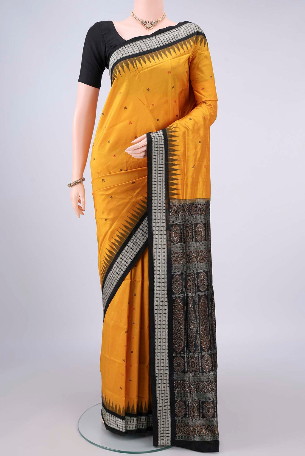 Pure Silk Mustard Orissa Saree with Thread Butta on the body and Thread Border.  displayed on a mannequin