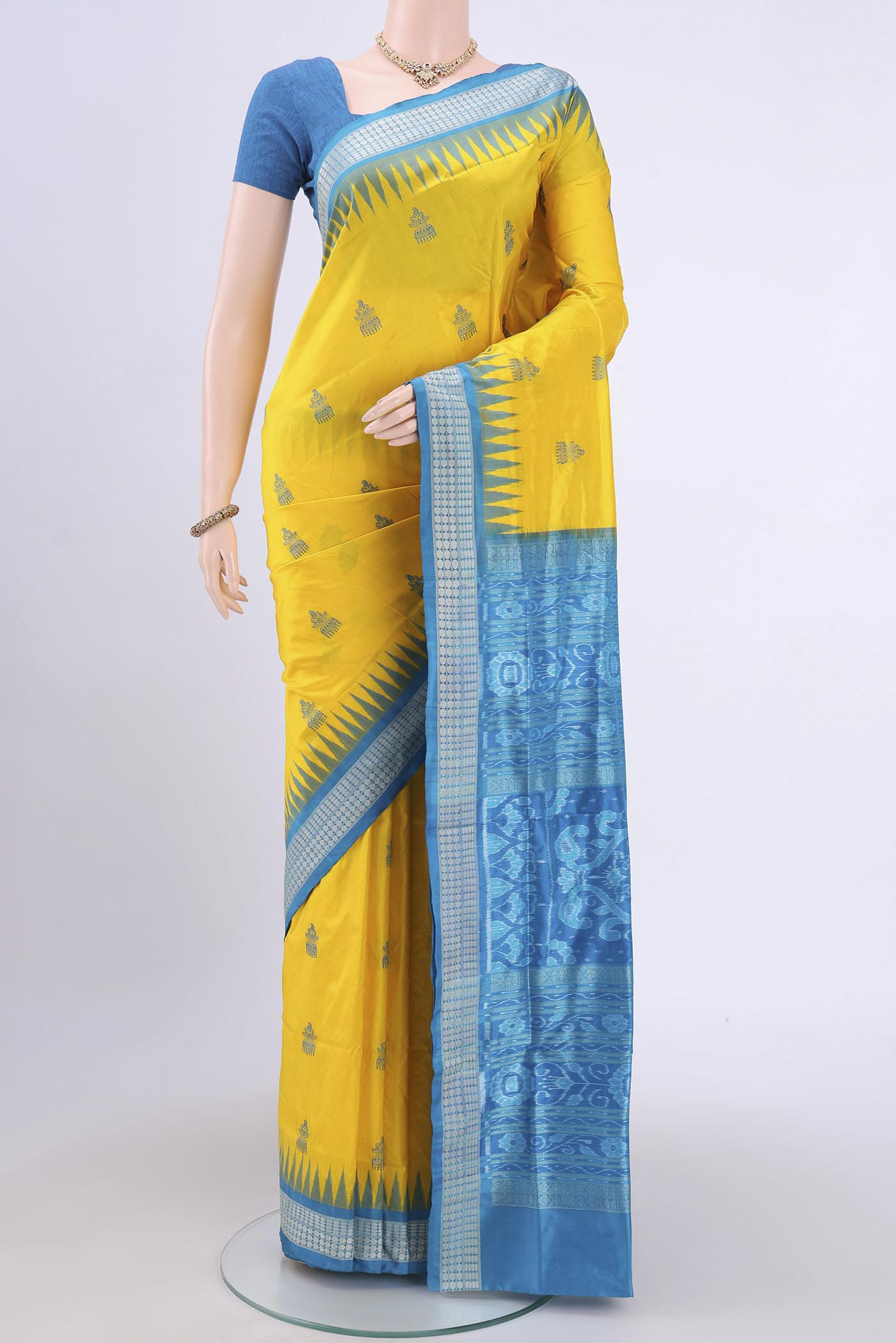 Yellow Orissa Silk Saree with Thread Butta on the body and Thread Border.  displayed on a mannequin