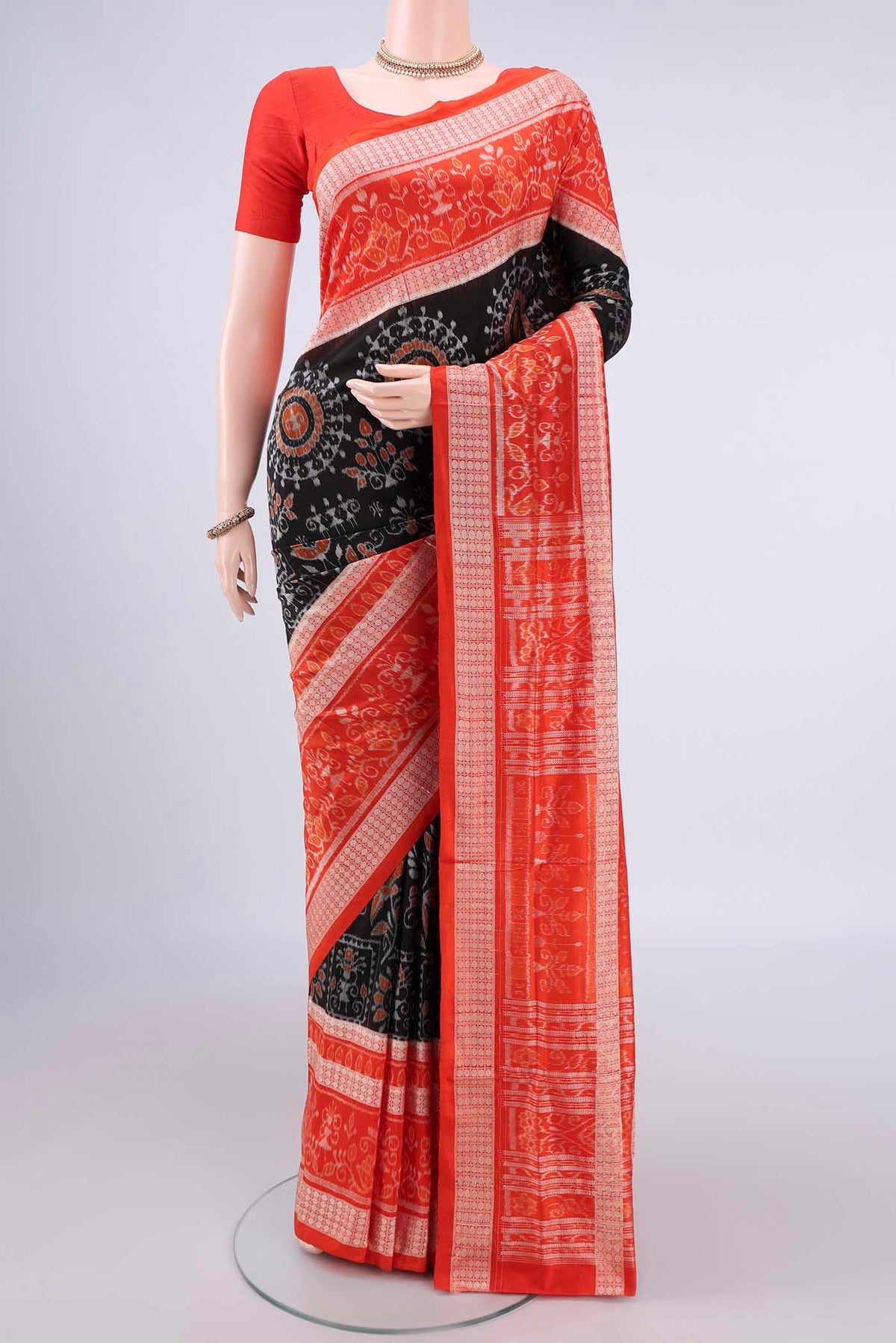 Pure Silk Black Orissa Saree with Pure Ikat on the body and Thread Border.  displayed on a mannequin