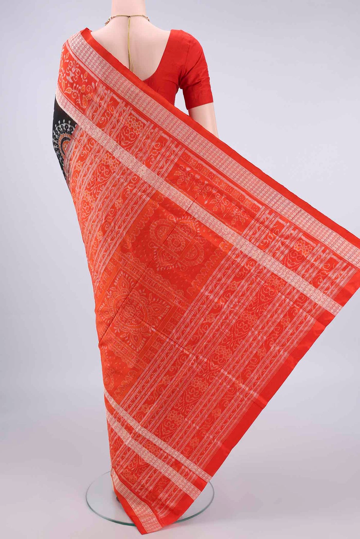 Flat view of Pure Silk Black Orissa Saree with Pure Ikat on the body and Thread Border. 