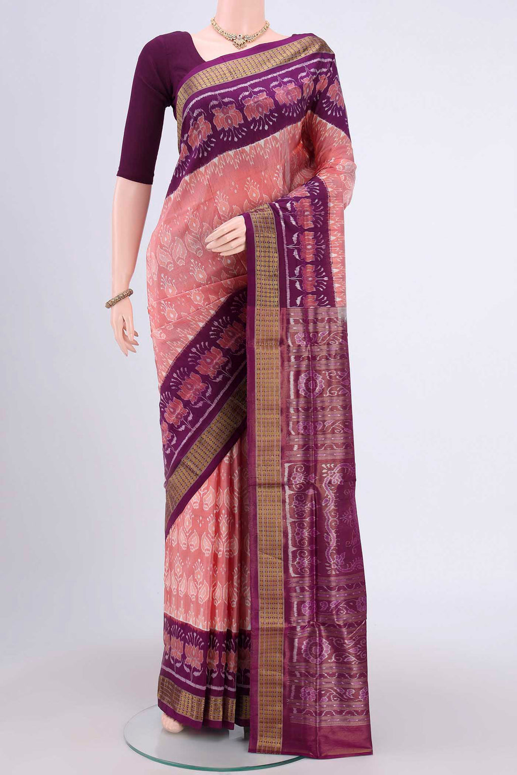 Peach Orissa Silk Saree with Ikat design on the body and Thread Border.  displayed on a mannequin