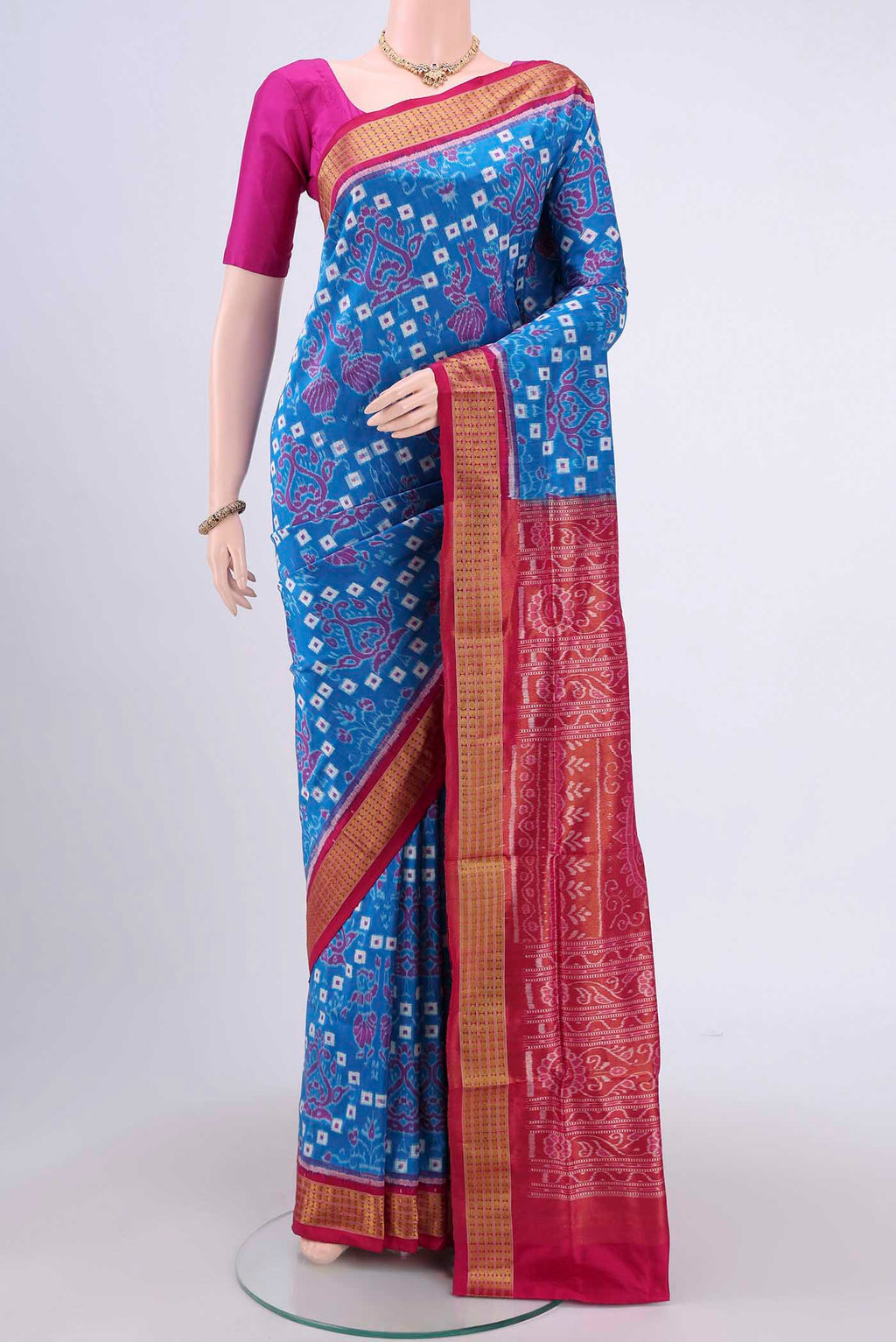 Blue Orissa Silk Saree with Ikat design on the body and Thread Border.  displayed on a mannequin