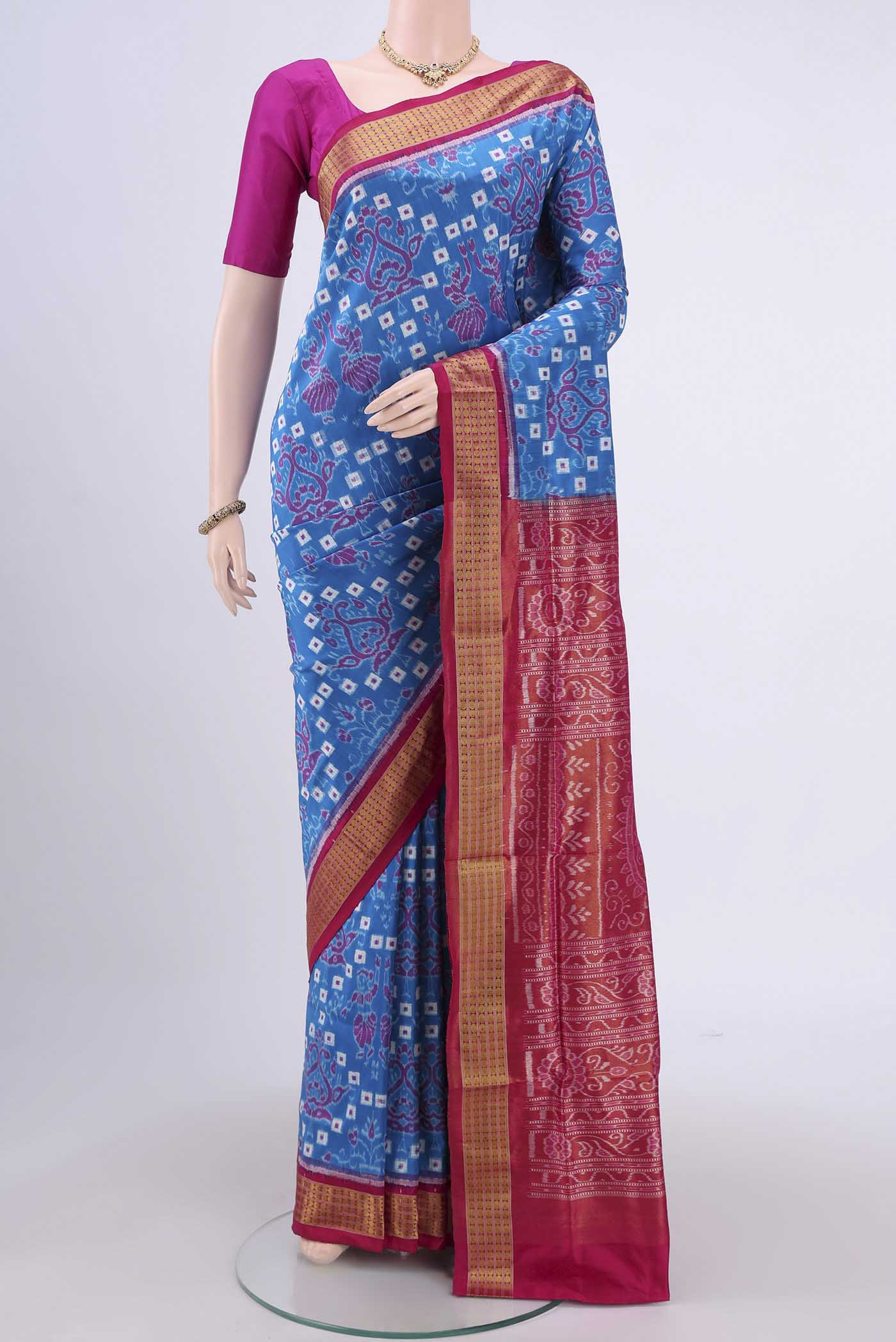 Blue Orissa Silk Saree with Ikat design on the body and Thread Border.  displayed on a mannequin