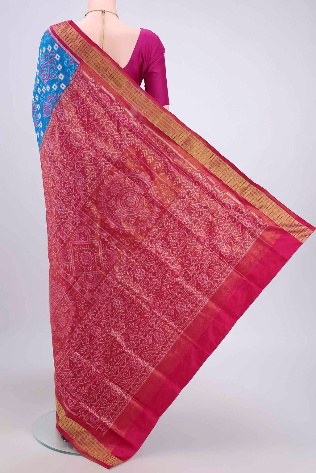 Flat view of Blue Orissa Silk Saree with Ikat design on the body and Thread Border. 