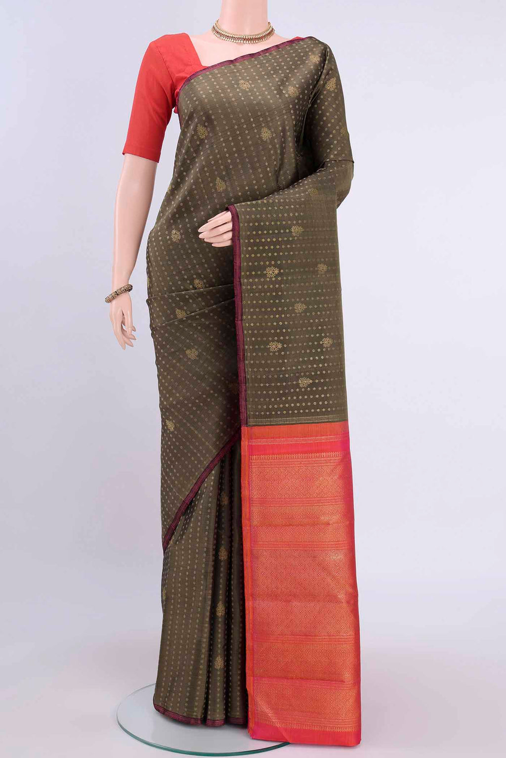 Pure Silk Pure Zari Brown Kanchipuram Saree with Zari Butta on the body and Without Border displayed on a mannequin