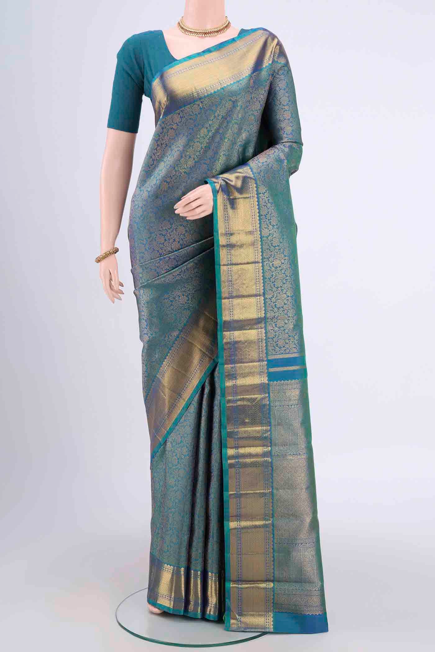 Pure Silk Pure Zari Sea Green Kanjivaram Saree with Zari Brocade on the body and Zari Border.  displayed on a mannequin