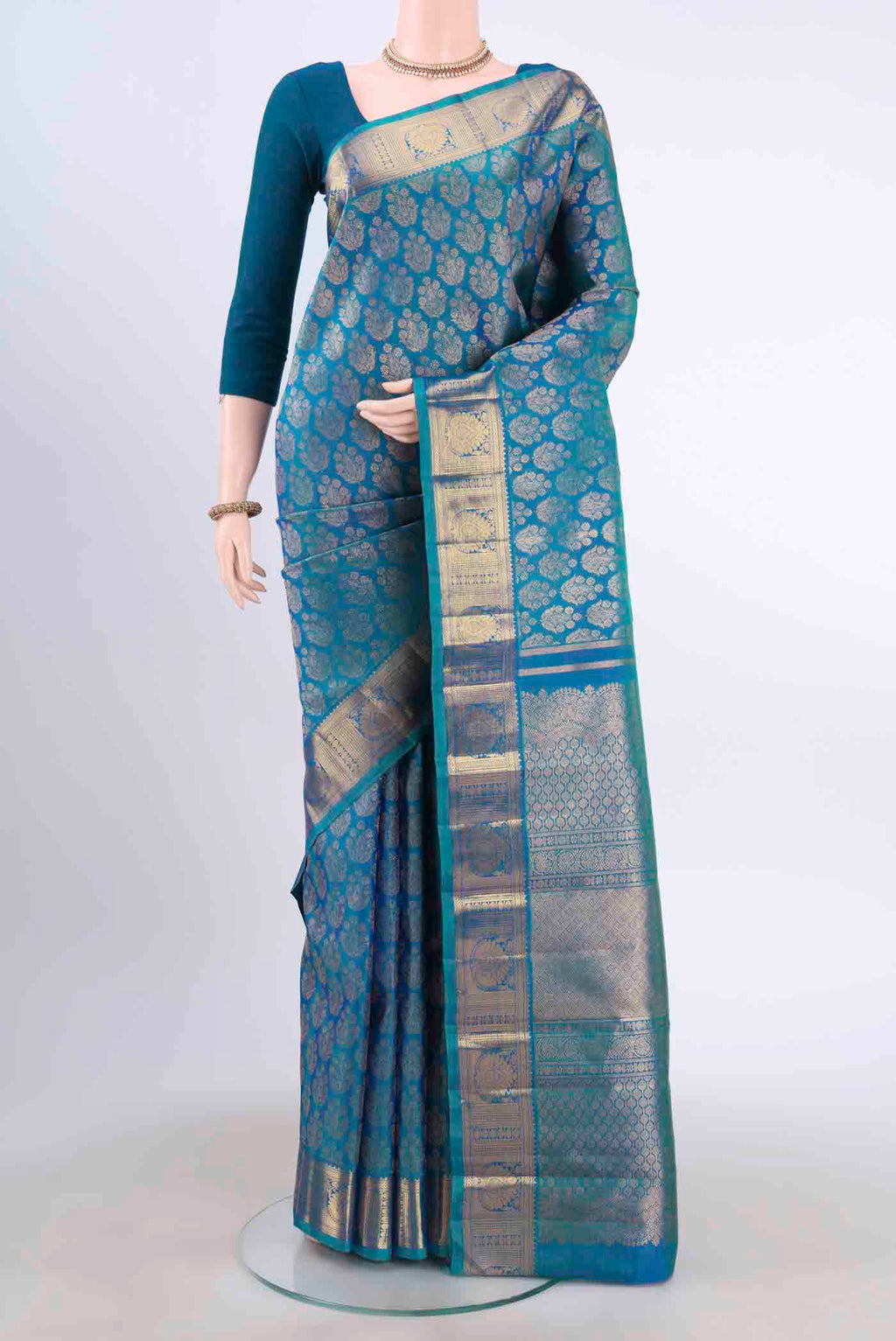 Pure Silk Pure Zari Blue Kanchipuram Saree with Zari Brocade on the body and Zari Border displayed on a mannequin