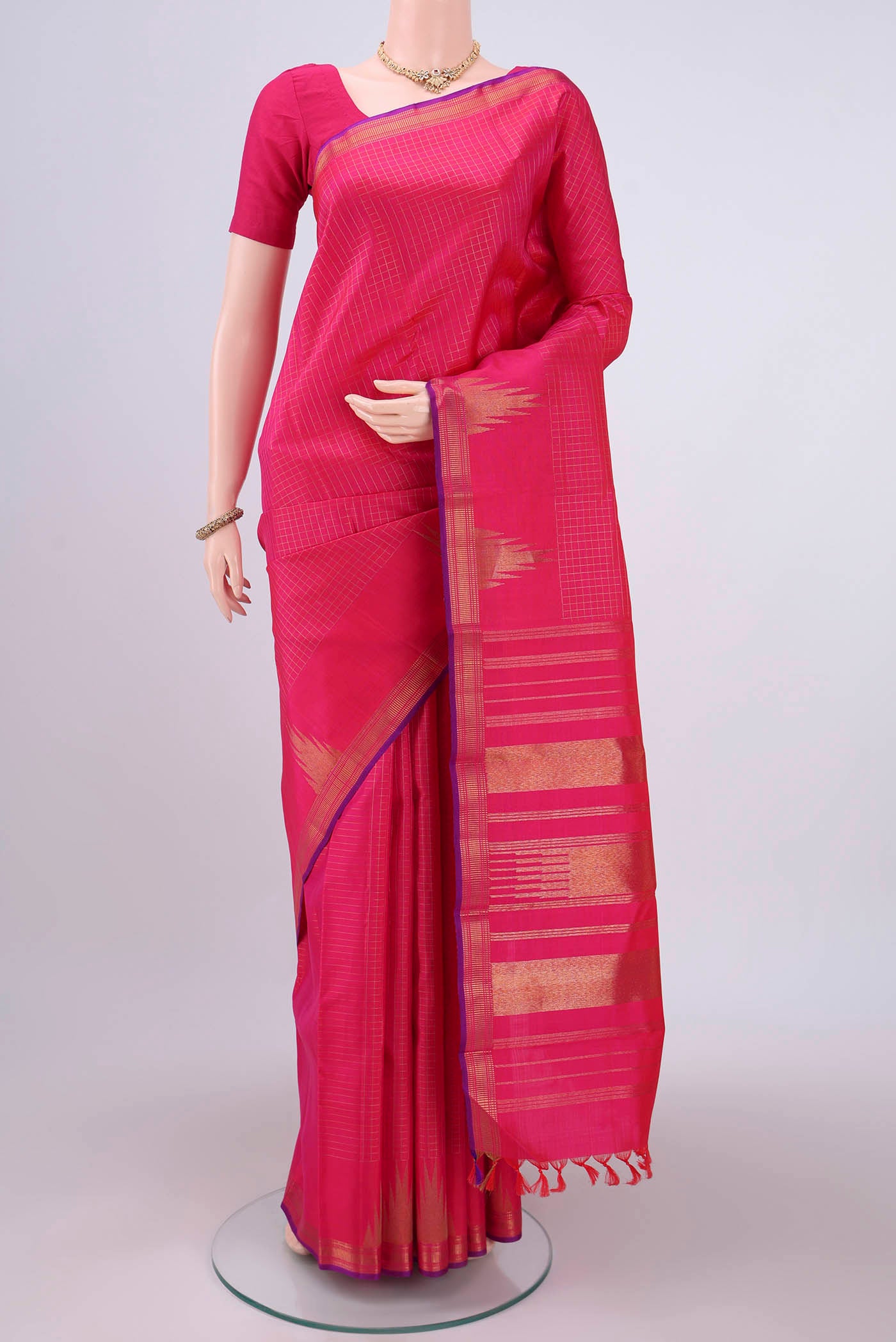 Pure Silk Pure Zari Dark Pink Kanchipuram Saree with Checked design on the body and Temple Border.  displayed on a mannequin
