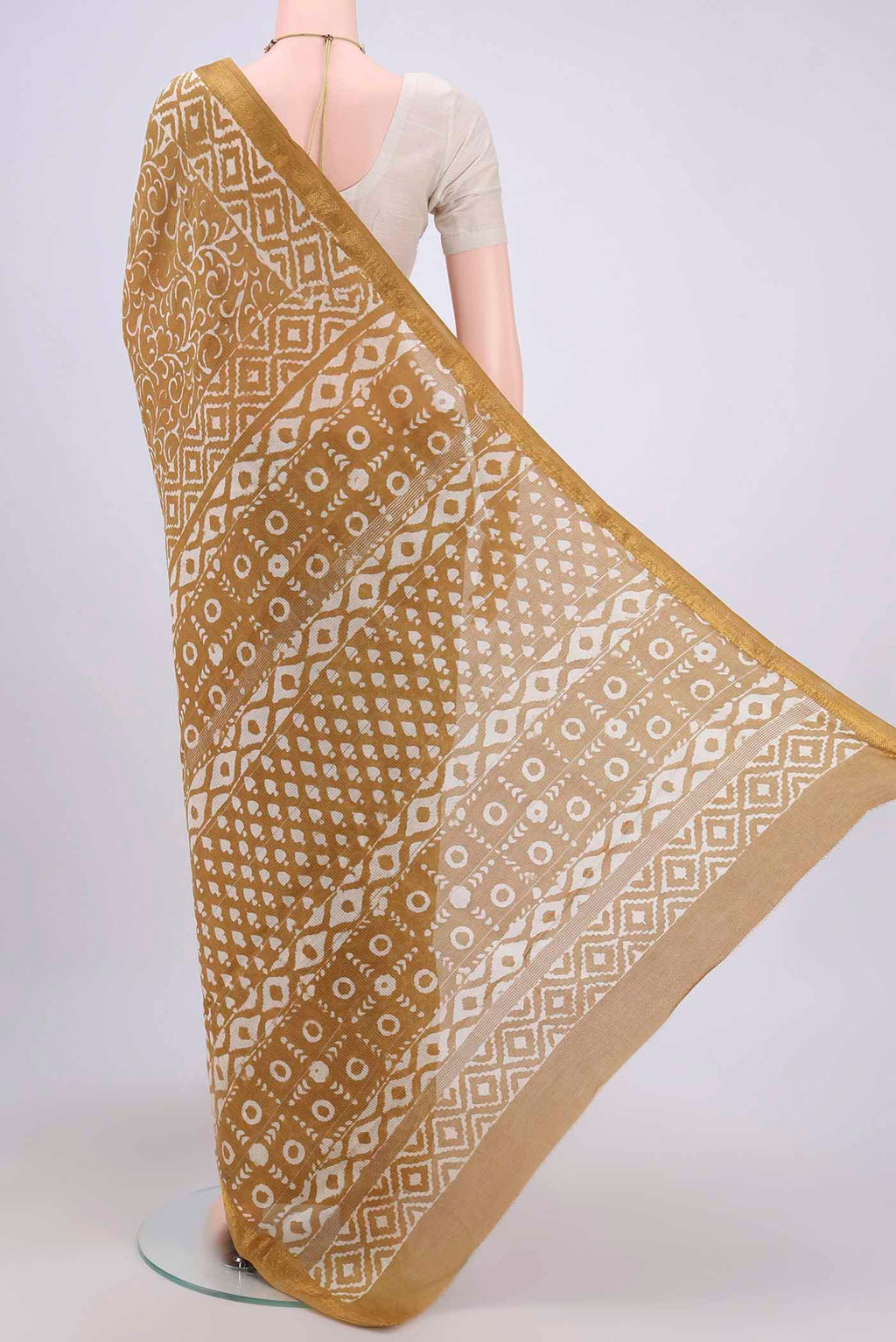 Flat view of Mustard Maheshwari Silk Cotton Saree with Printed design on the body and Zari Border. 