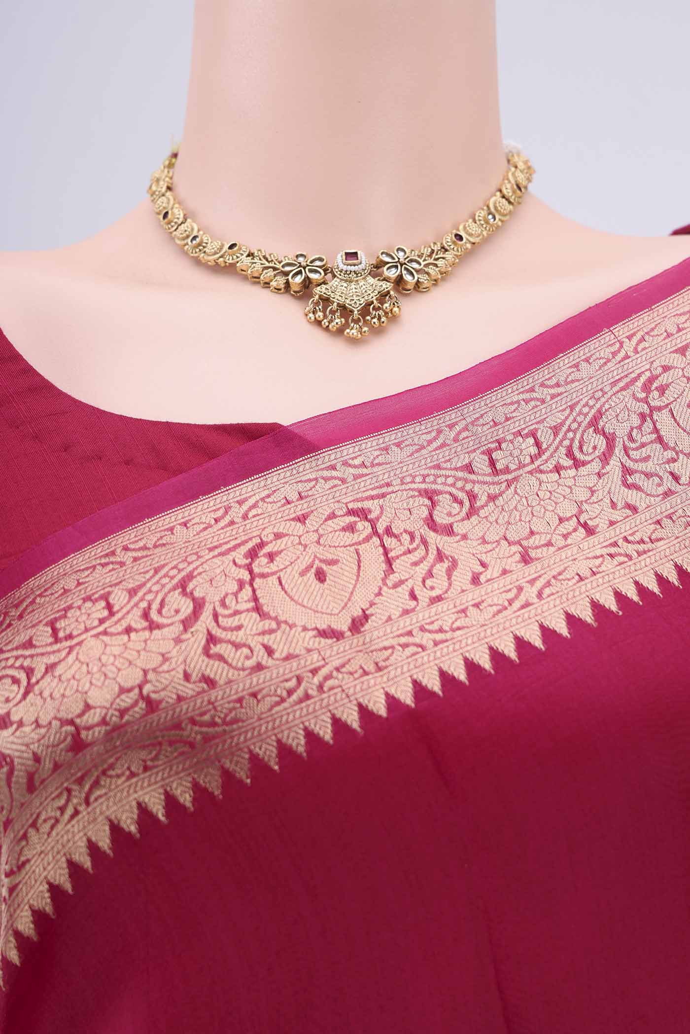 Border image of Rani Pink Organza Silk Saree with Plain Body and Zari Border. 