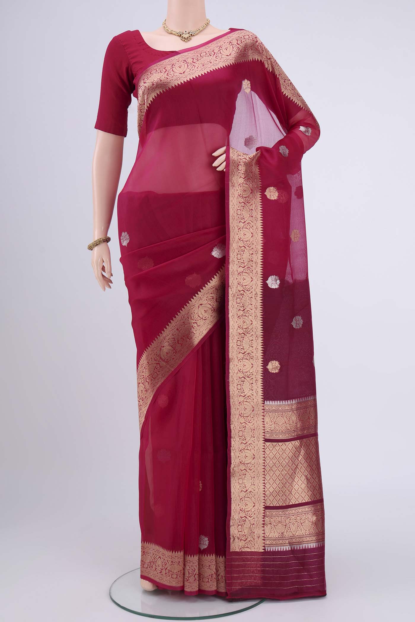 Rani Pink Organza Silk Saree with Plain Body and Zari Border.  displayed on a mannequin