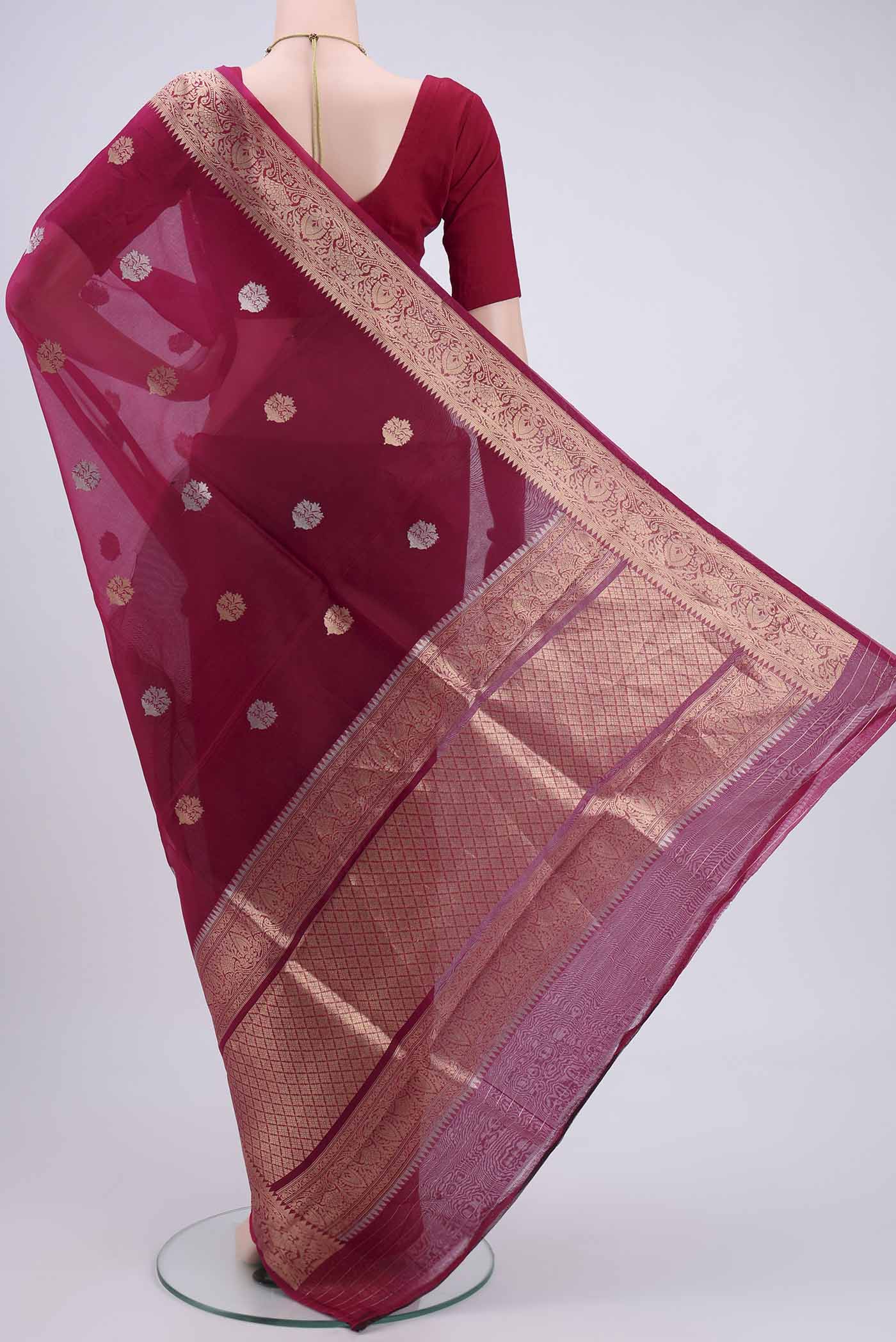 Flat view of Rani Pink Organza Silk Saree with Plain Body and Zari Border. 