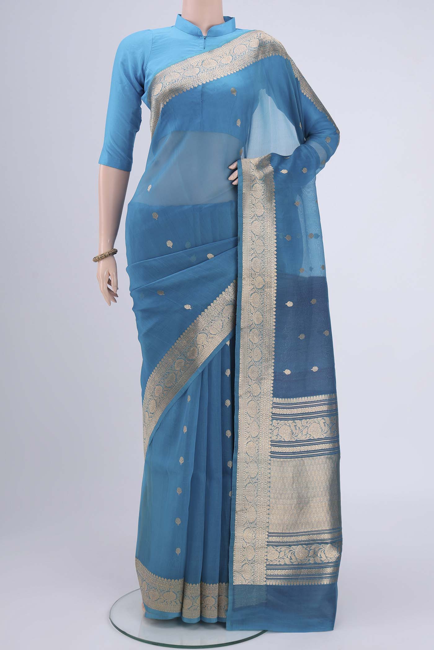 Blue Organza Silk Saree with Zari Butta on the body and Zari Border.  displayed on a mannequin