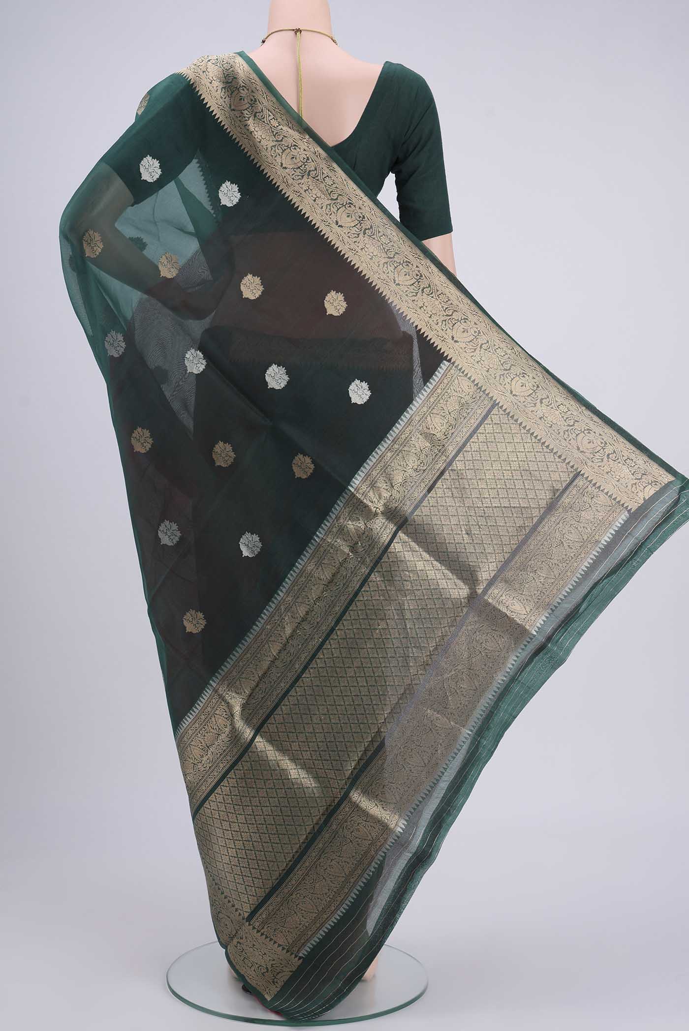 Flat view of Bottle Green Organza Silk Saree with Plain Body and Zari Border. 