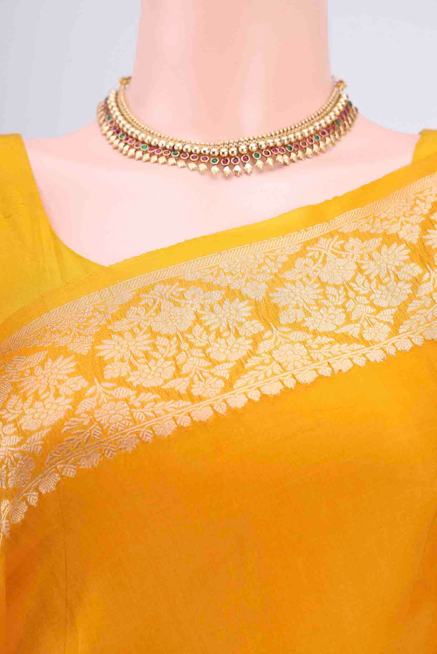 Border image of Mustard Organza Silk Saree with Zari Butta on the body and Zari Border