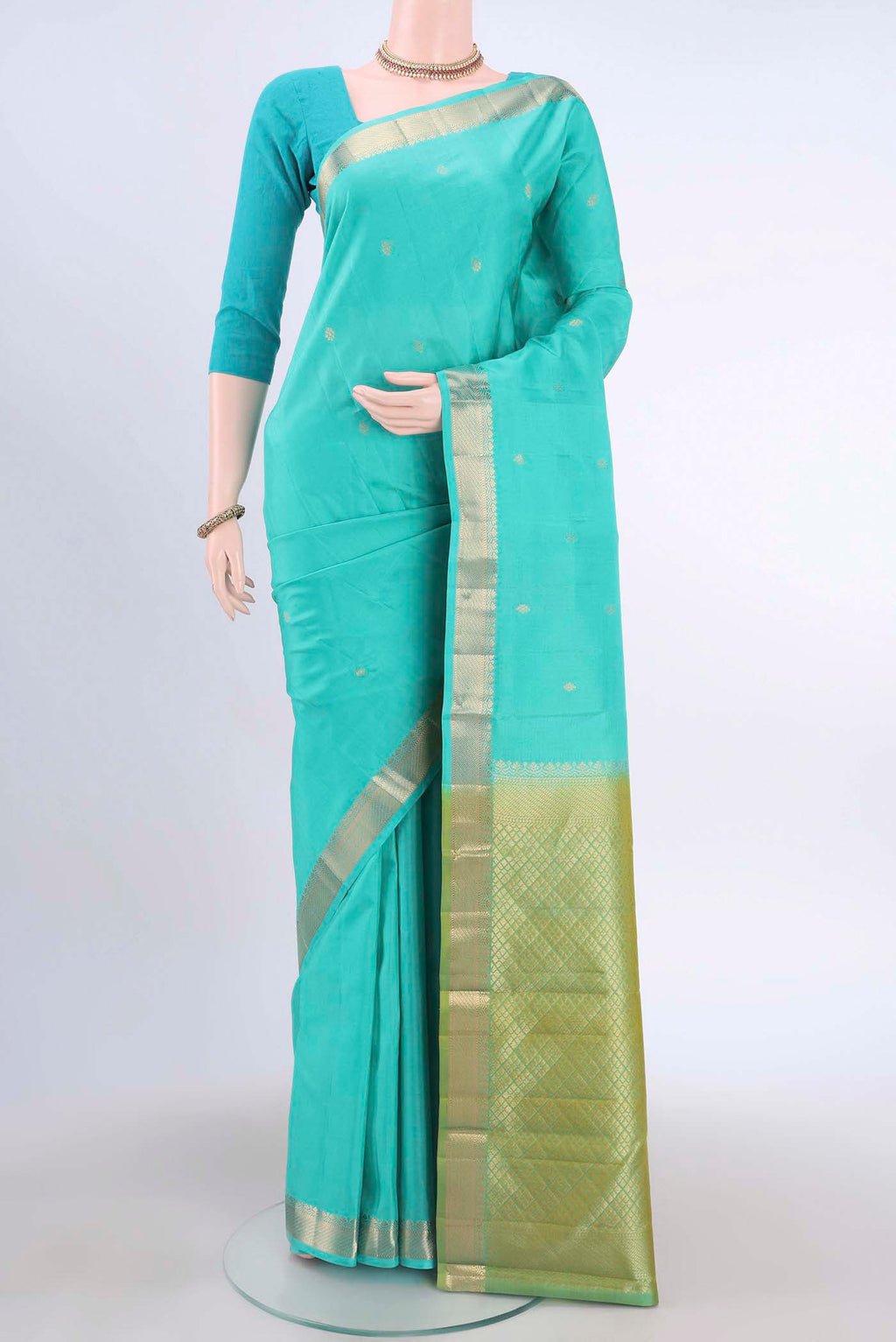 Turquoise Kanchipuram Silk Saree with Zari Butta on the body and Zari Border displayed on a mannequin