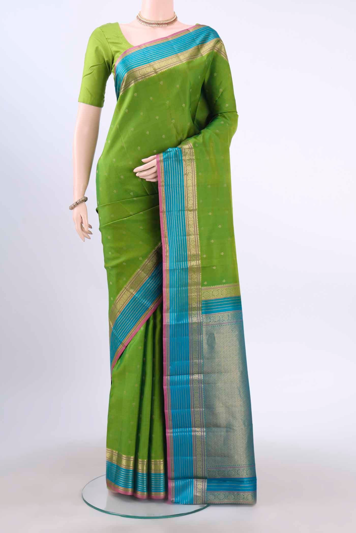 Green Kanchipuram Silk Saree with Zari Butta on the body and Zari Border displayed on a mannequin