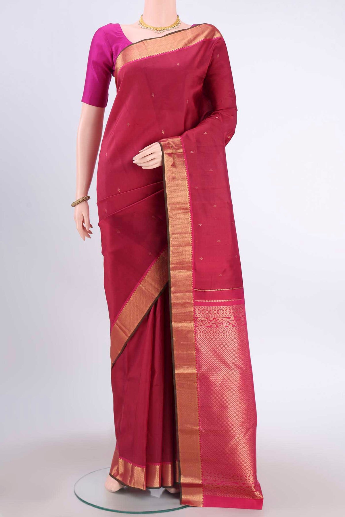 Maroon Kanchipuram Silk Saree with Zari Butta on the body and Zari Border displayed on a mannequin