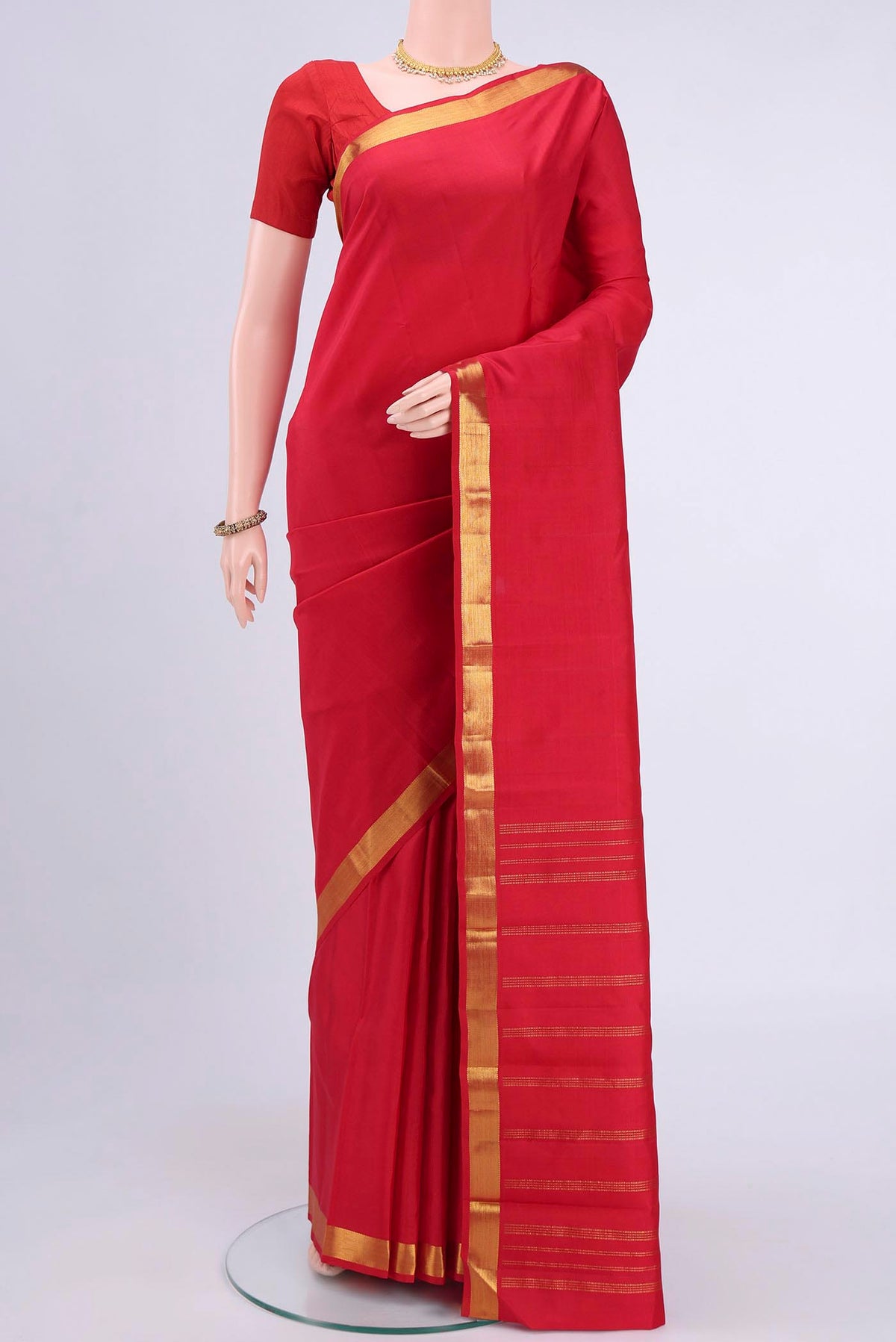 Red Kanchipuram Saree with Plain Body and Zari Border displayed on a mannequin