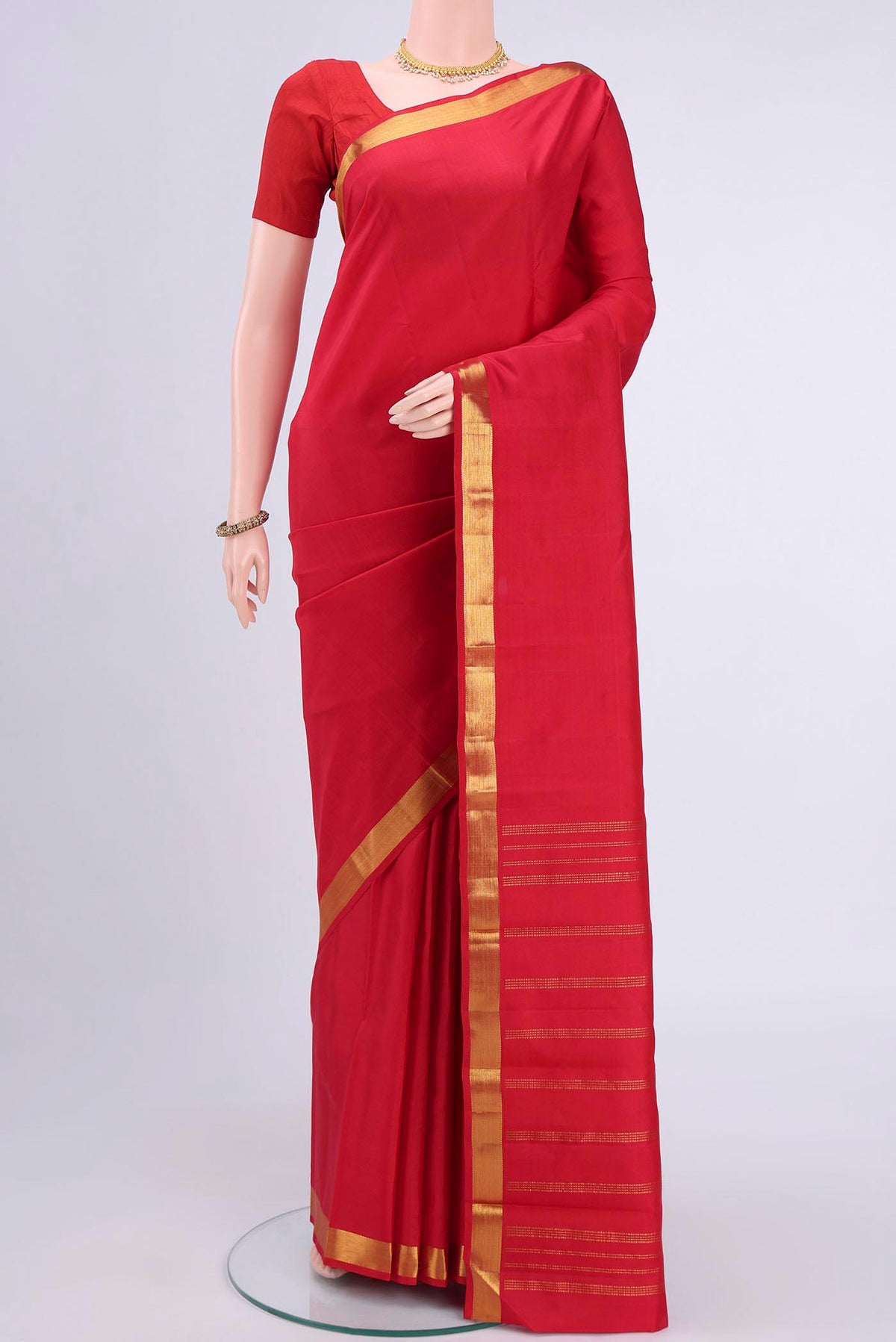 Red Kanchipuram Saree with Plain Body and Zari Border displayed on a mannequin