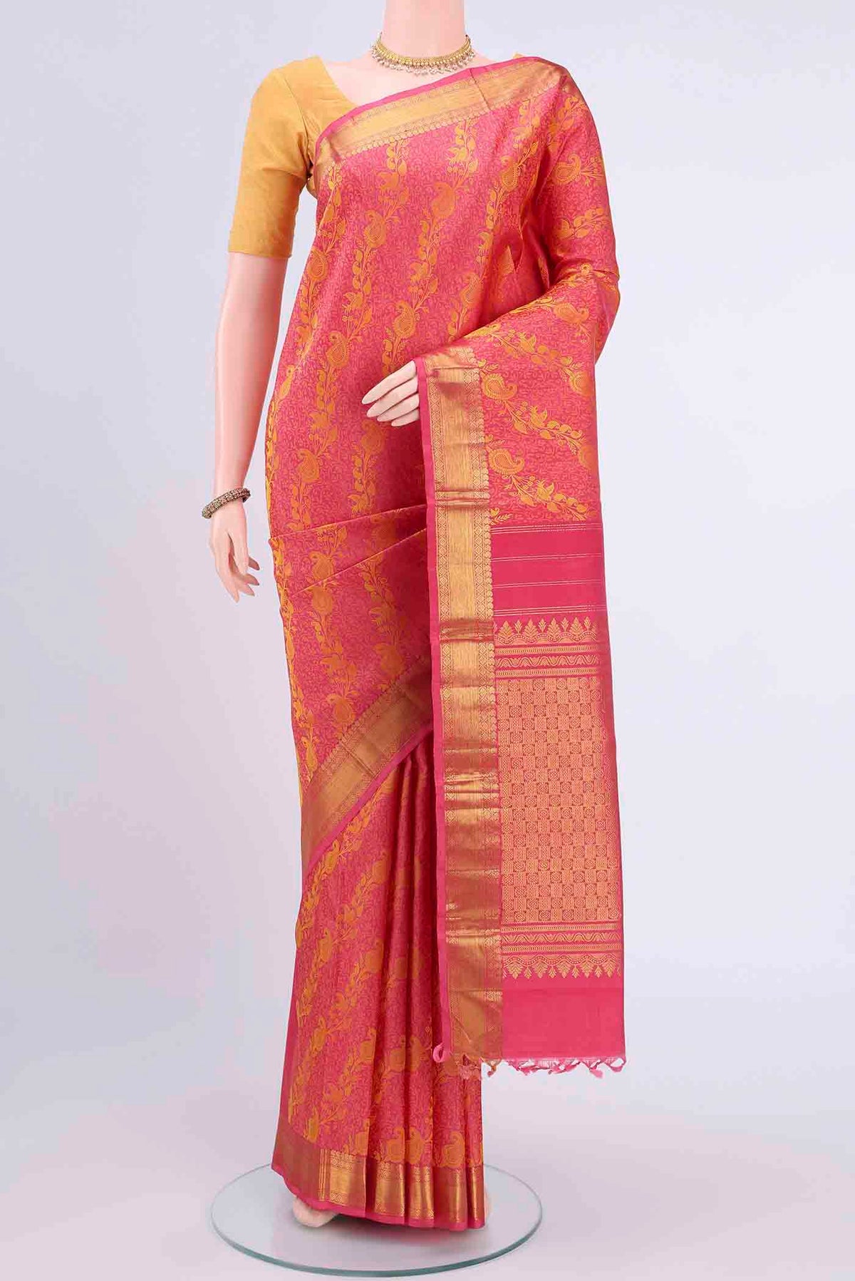 Pink Kanchipuram Saree with Jacquard design on the body and Zari Border displayed on a mannequin