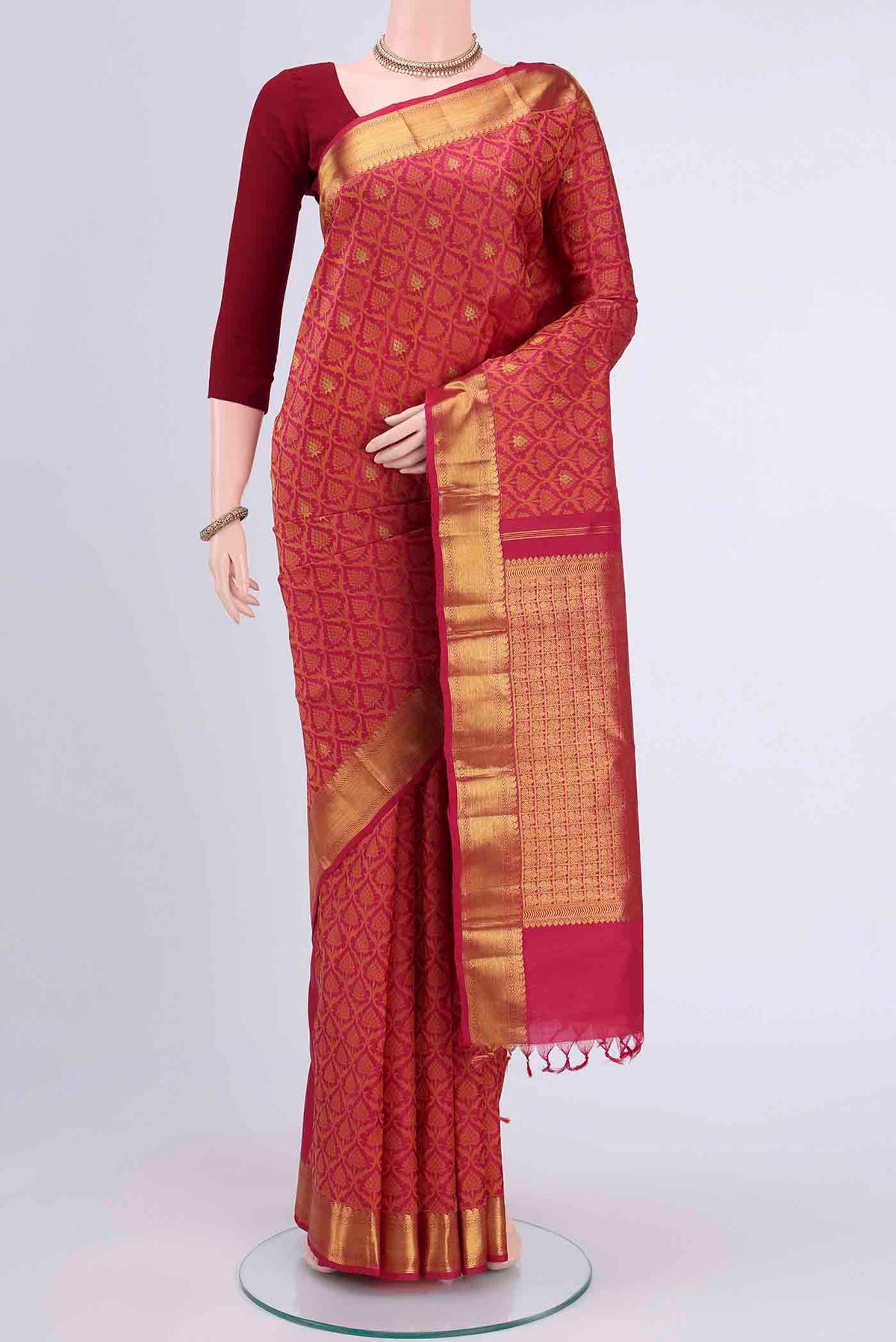 Maroon Kanchipuram Saree with Jacquard With Zari Butta on the body and Thread Border displayed on a mannequin