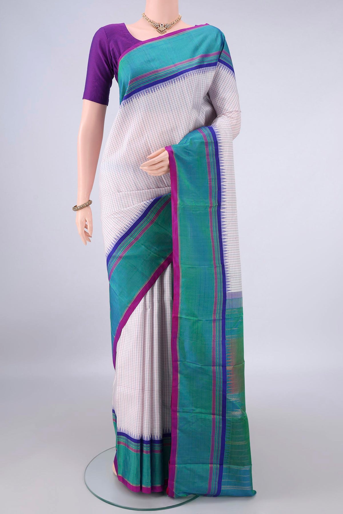 Pure Silk Off White Kanjivaram Saree with Checked design on the body and Plain Border.  displayed on a mannequin