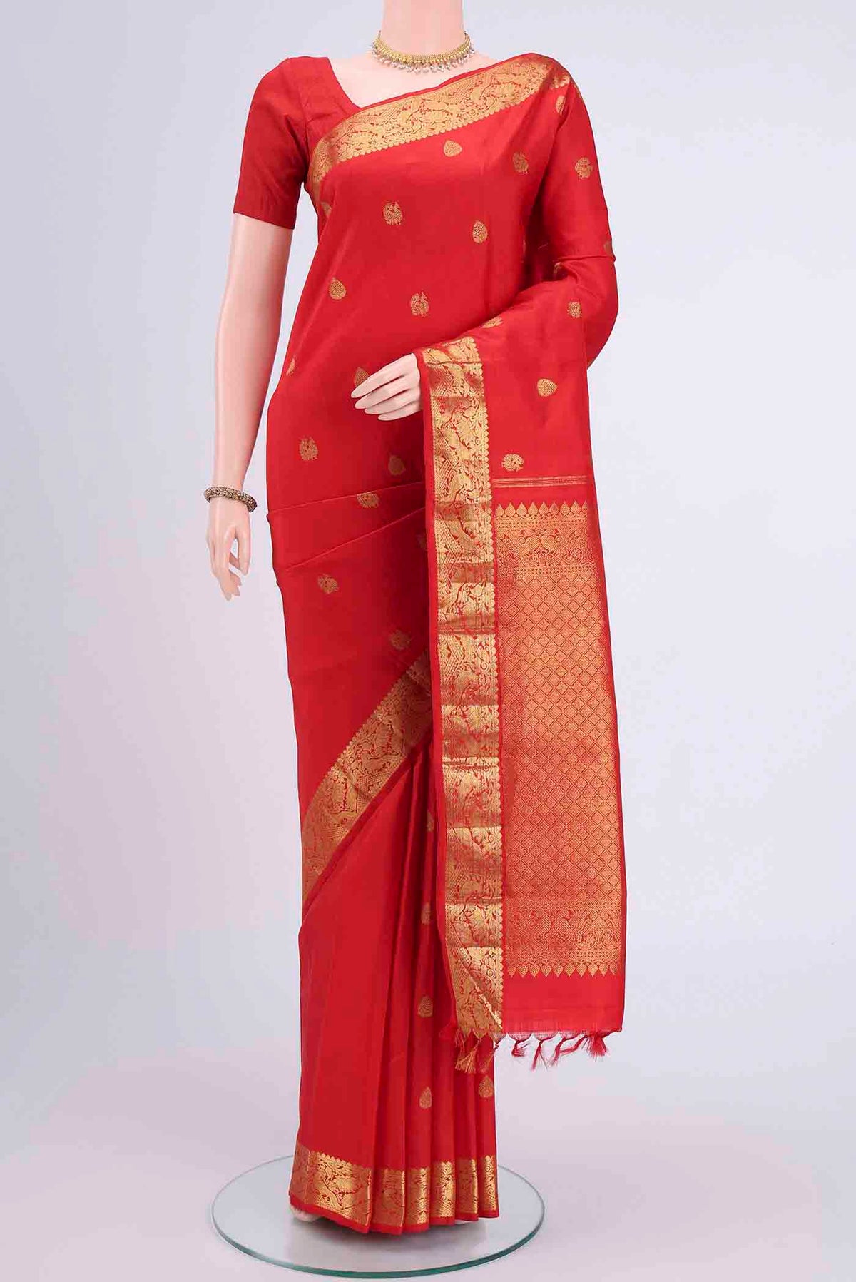 Imperial Red Kanchipuram Saree with Zari Butta on the body and Zari Border displayed on a mannequin