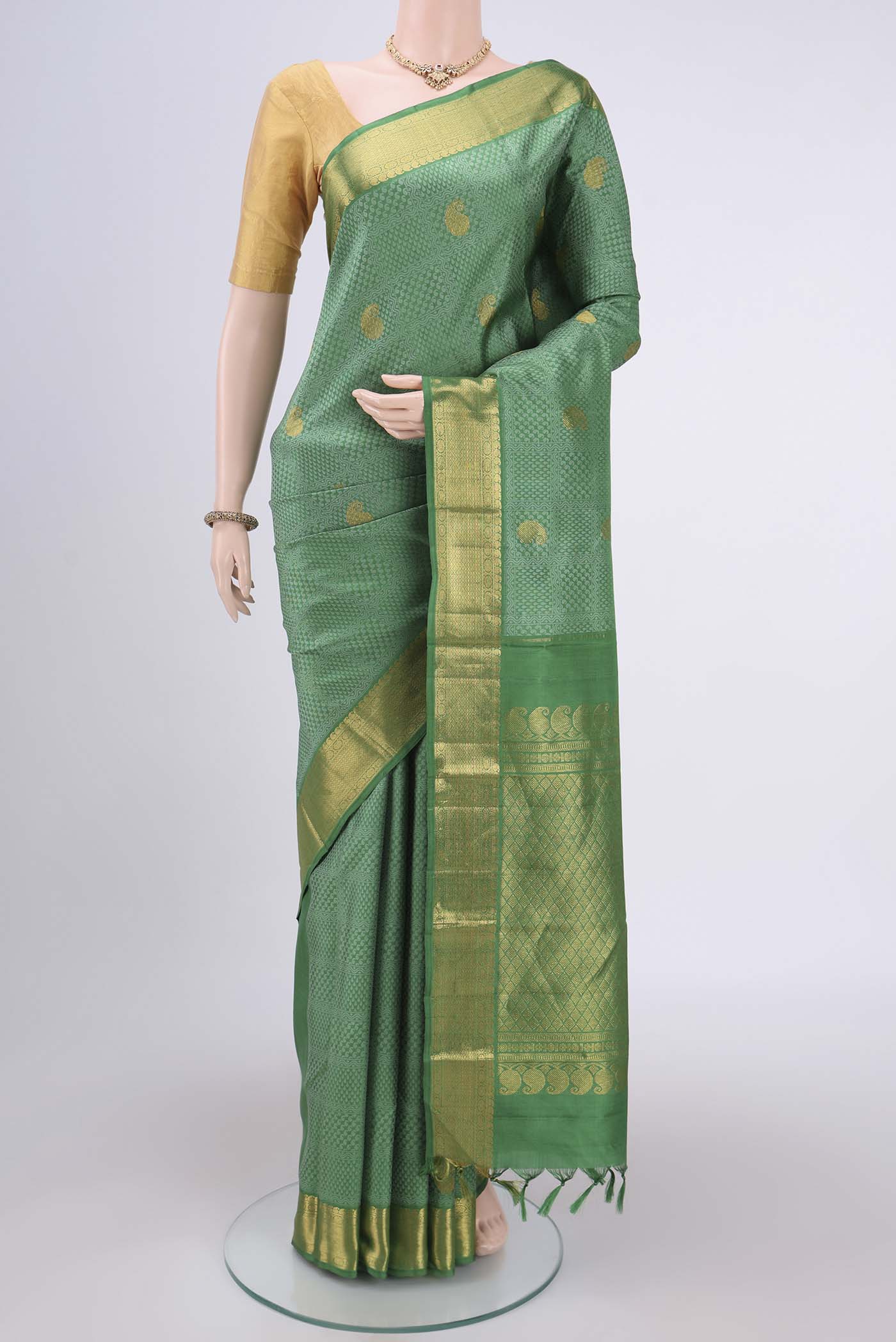 Green Kanjivaram Silk Saree with Jacquard With Zari Butta on the body and Zari Border.  displayed on a mannequin