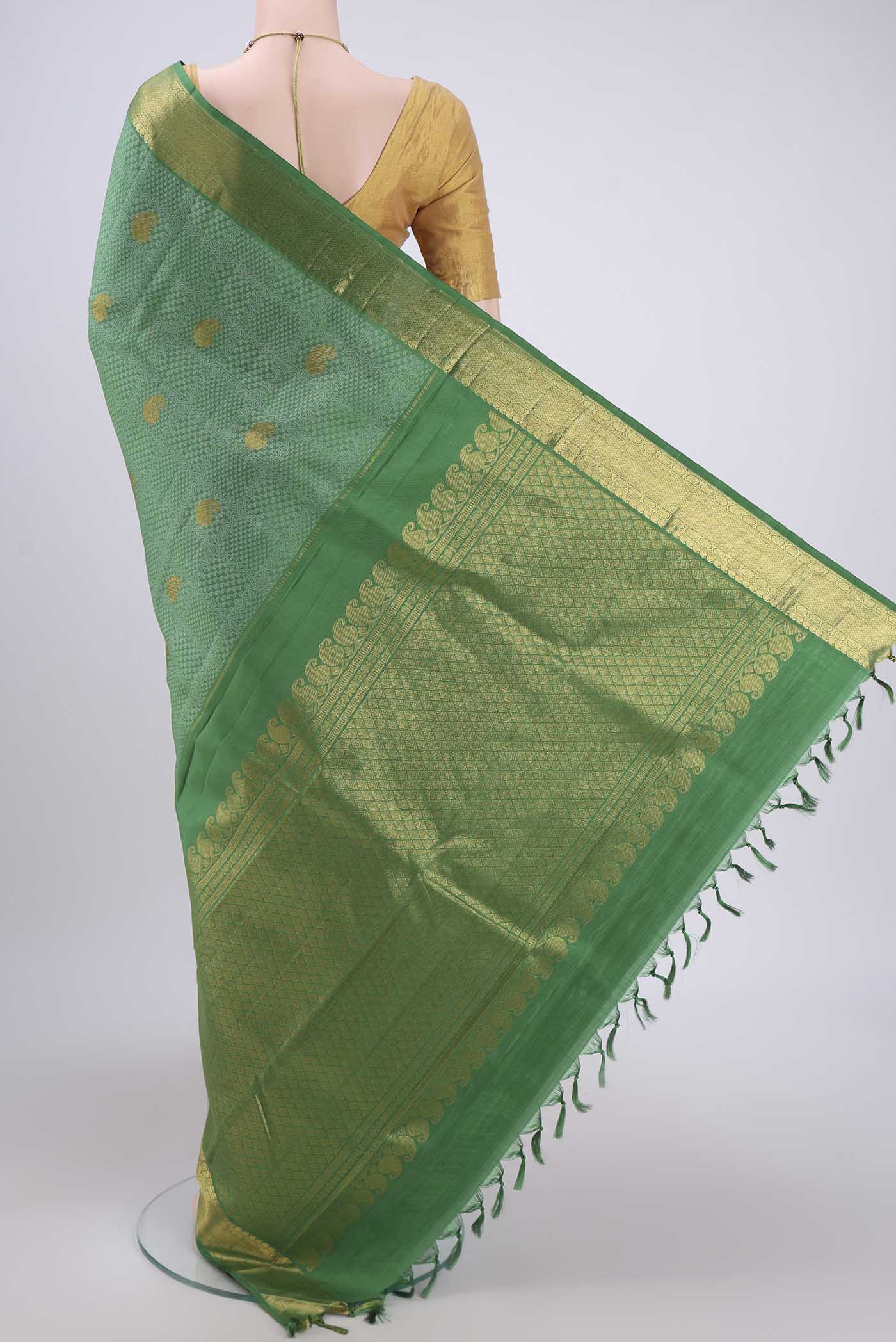 Flat view of Green Kanjivaram Silk Saree with Jacquard With Zari Butta on the body and Zari Border. 