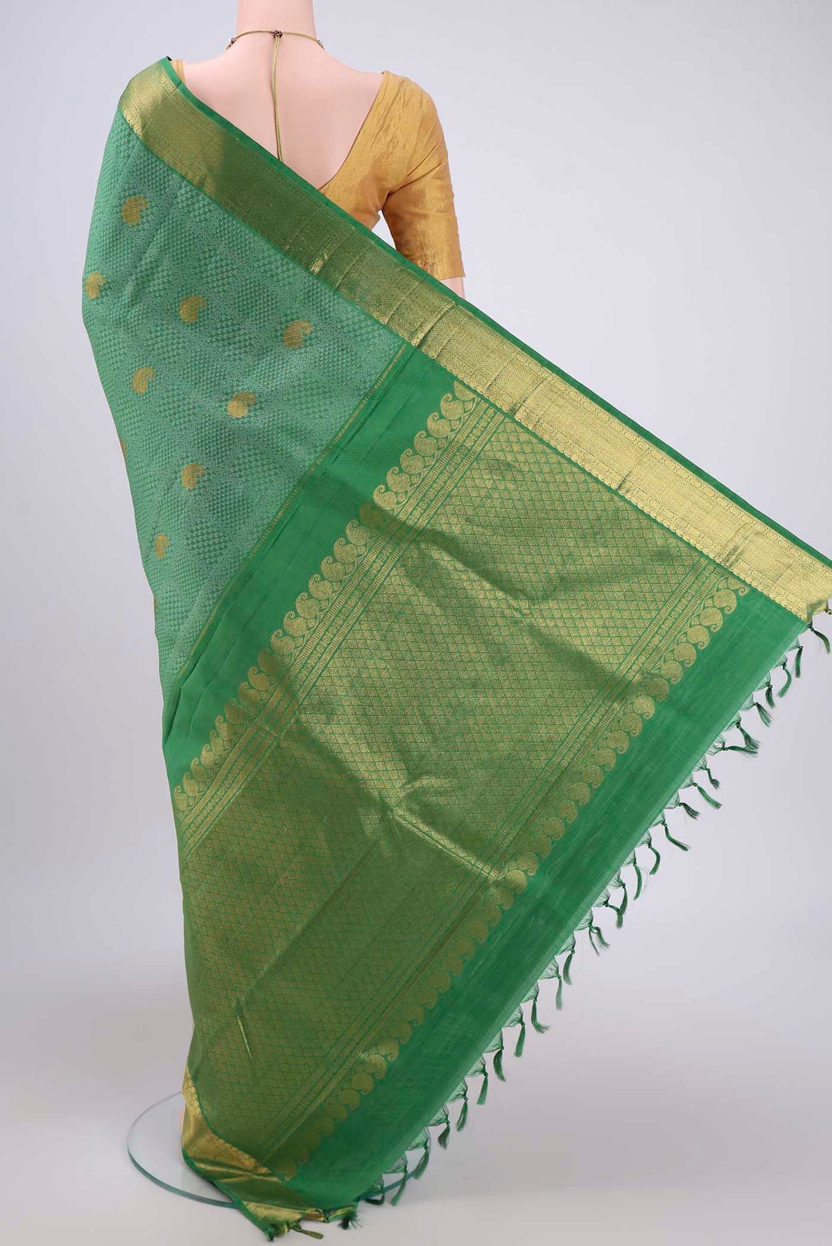 Flat view of Green Kanjivaram Silk Saree with Jacquard With Zari Butta on the body and Zari Border. 